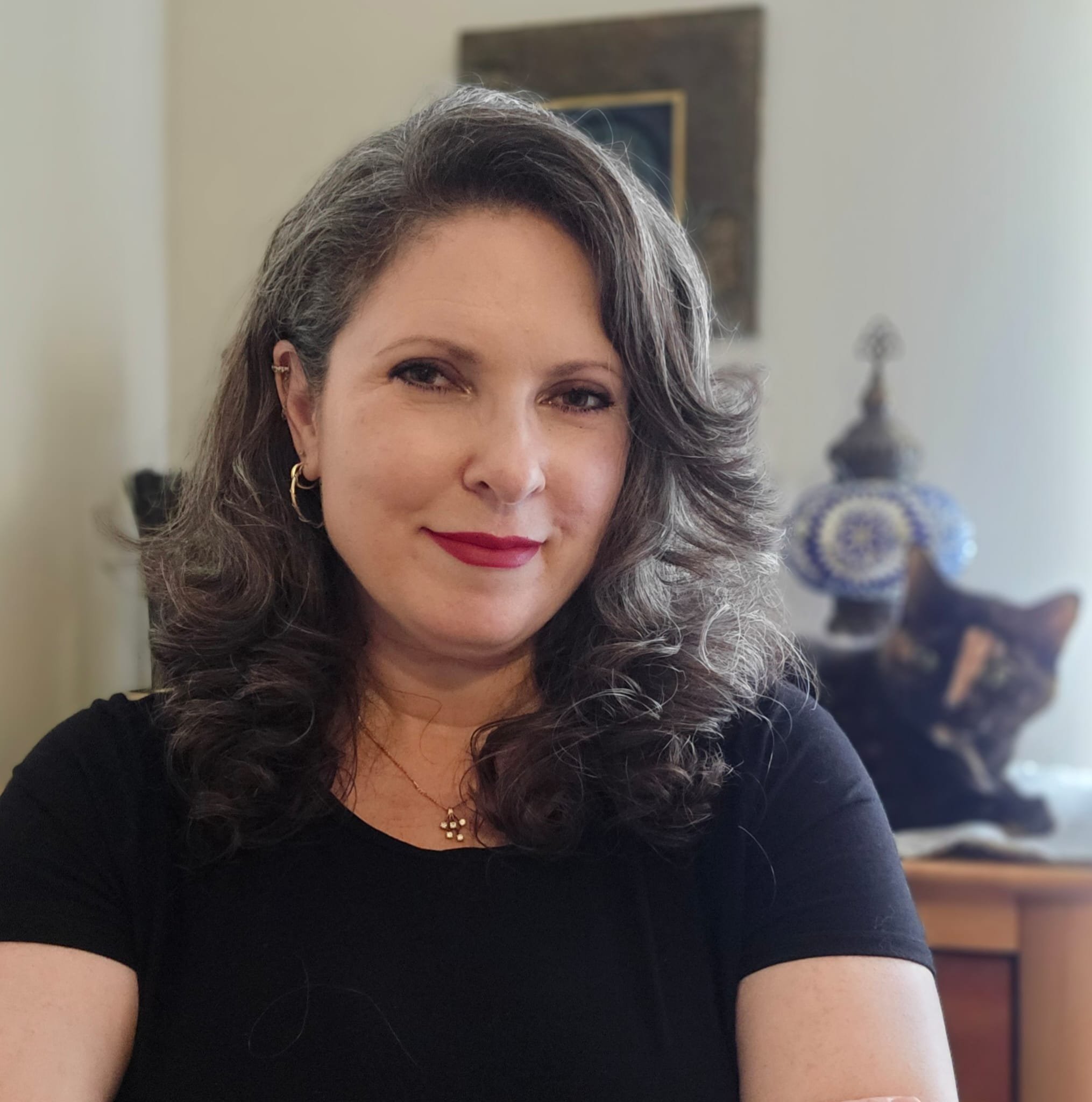 Sharon Windham, therapist and intimacy coach, in her Houston office with one of her cats.