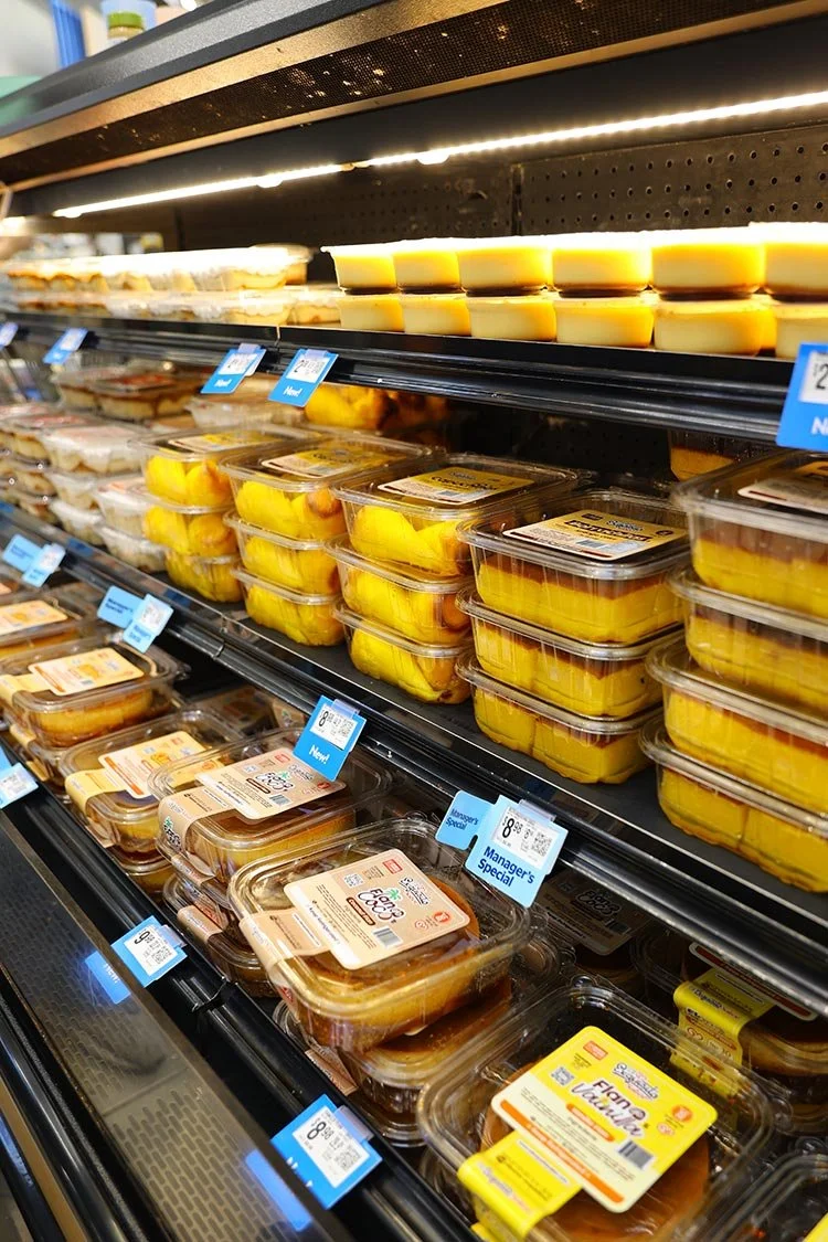Close-up of El Exquisito Sabor flan containers inside Walmart cooler