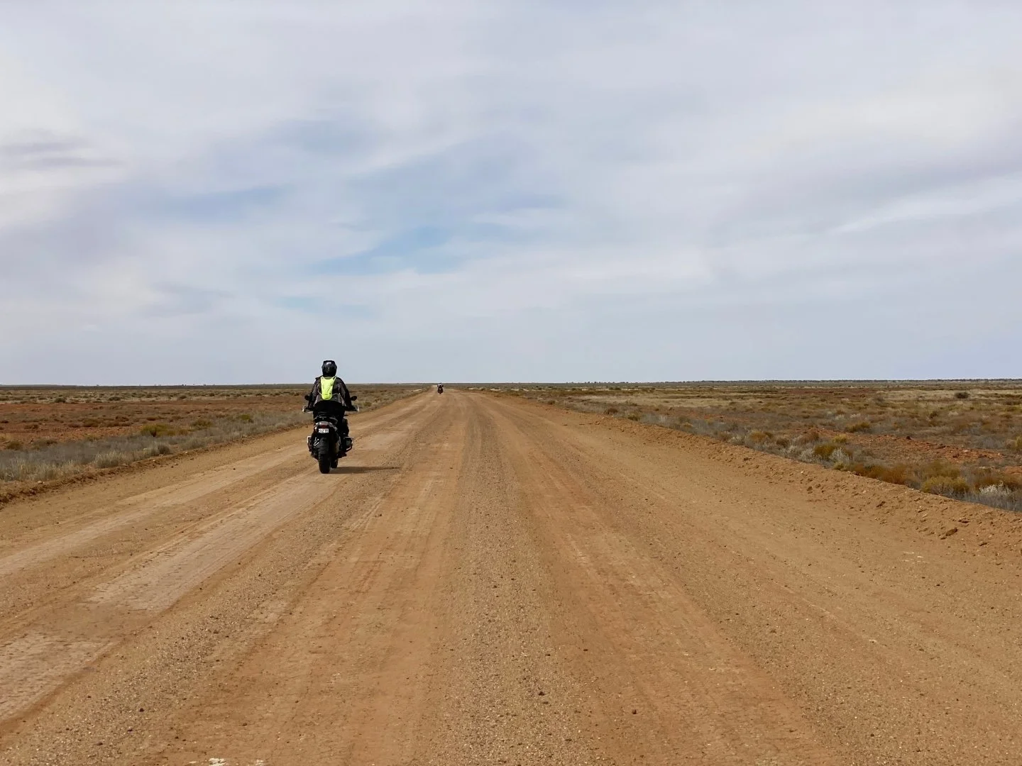 This one is OF me, instead of BY me. Riding in the outback somewhere in South Australia. The land is flat and the road seemingly stretches on forever.