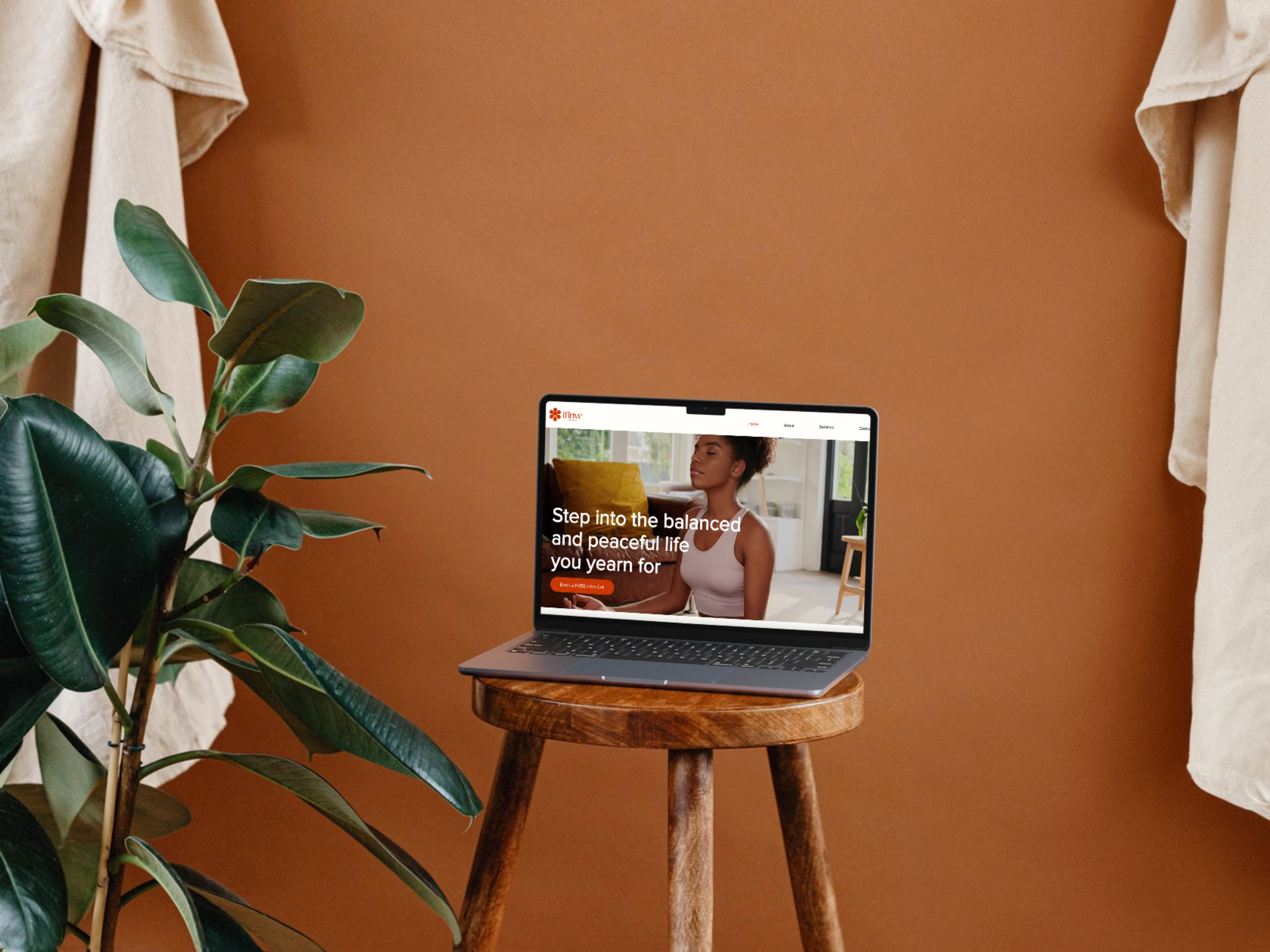 website design for a luxury health and wellness brand. laptop on a stool showing website preview