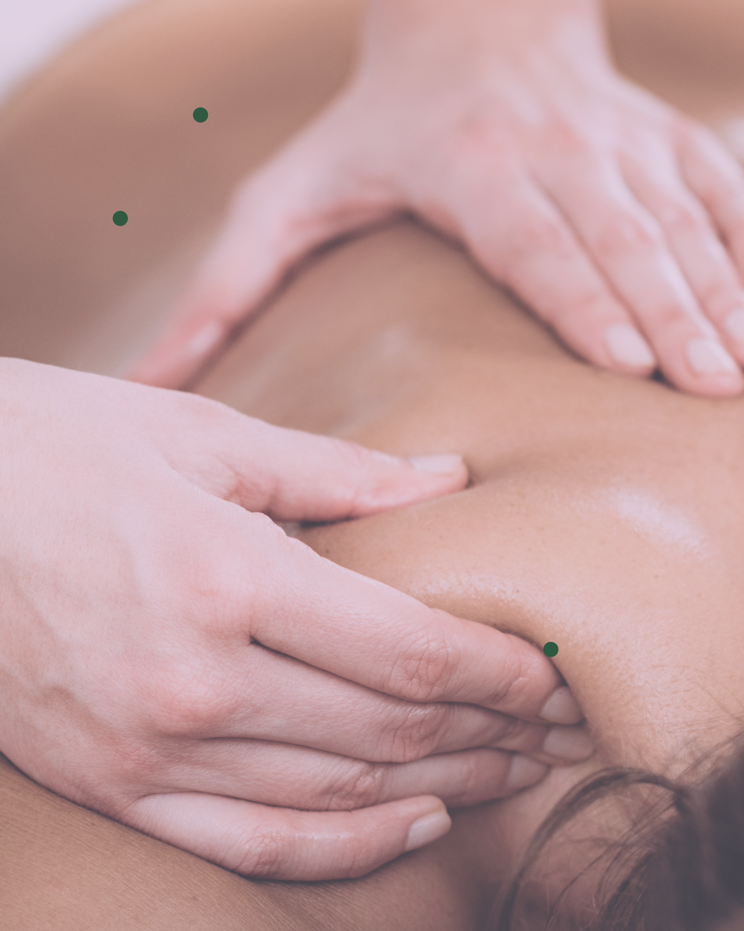 A massage therapist giving a massage on a person's shoulder and upper back.