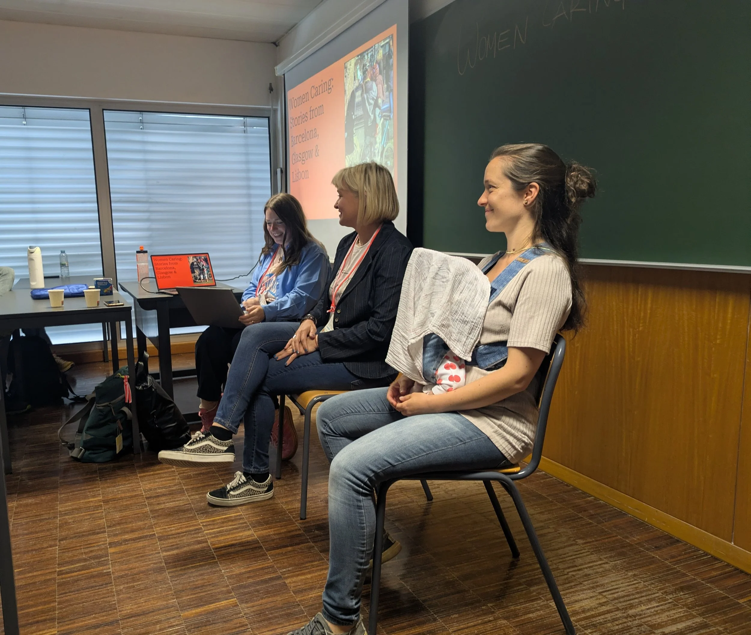 Three women and a baby sat on chairs