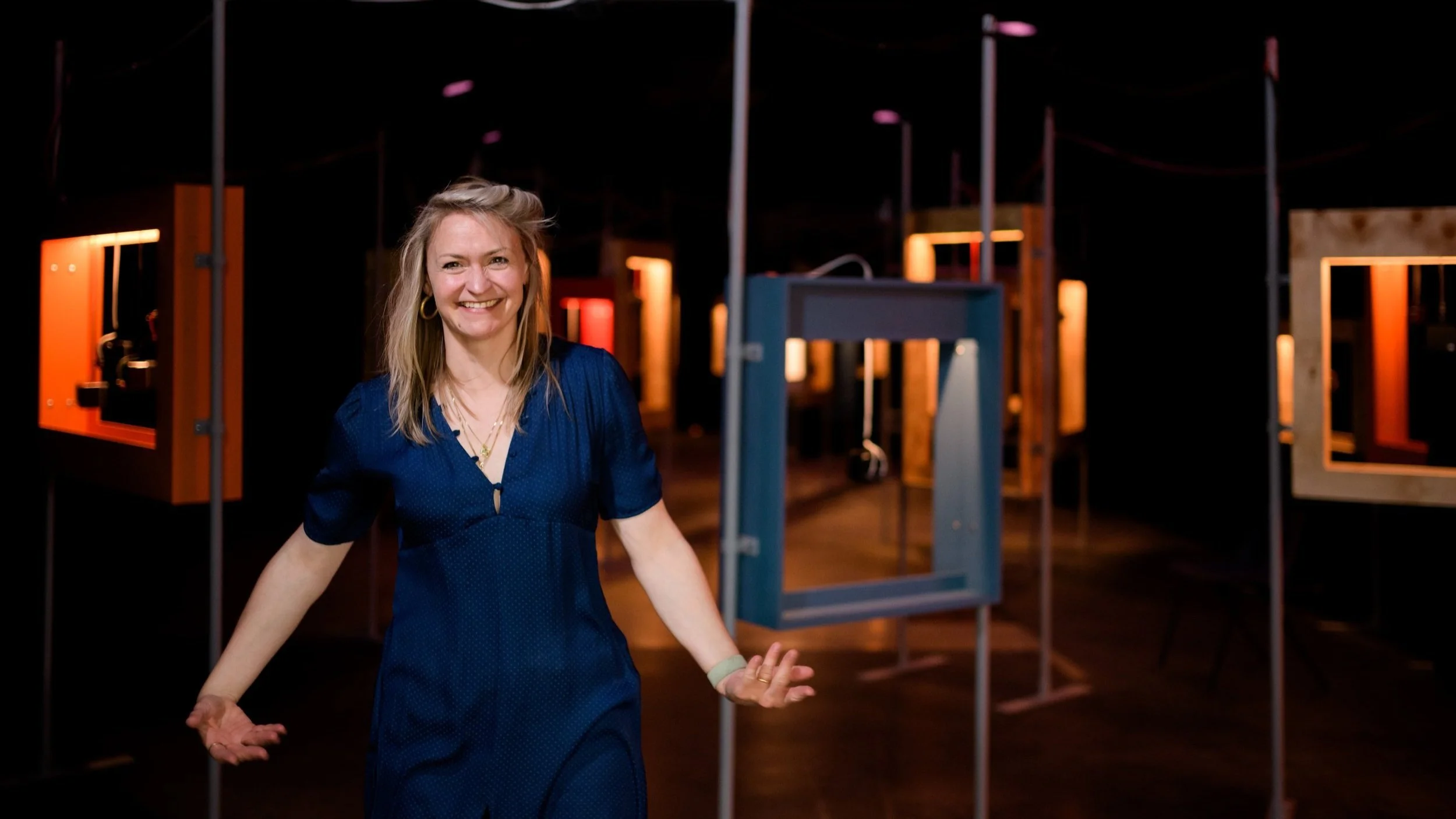A photo of Verity Standen, wearing blue, smiling at the camera