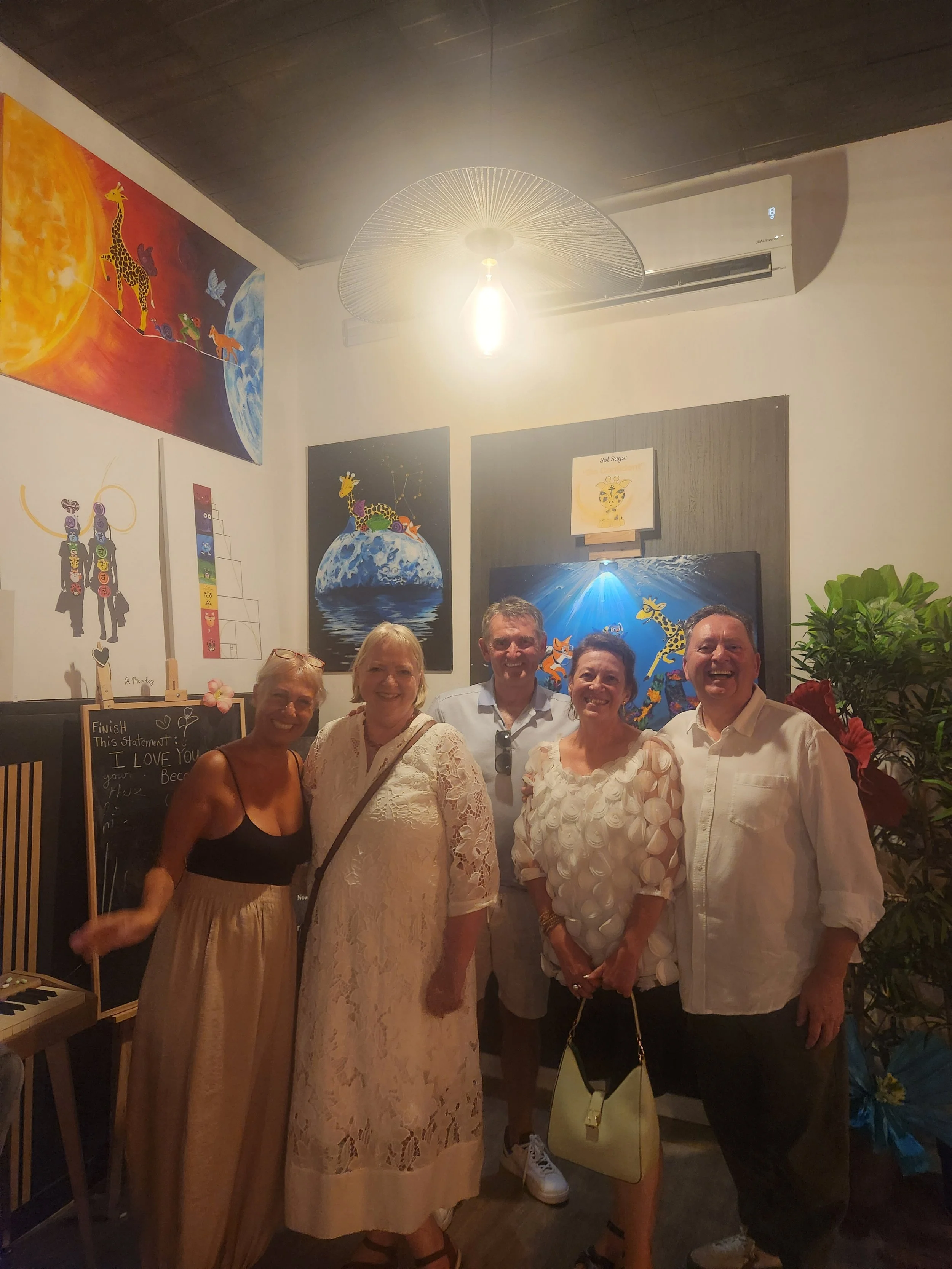 Group of six fans posing indoors with the I love you because... art Exhibition.