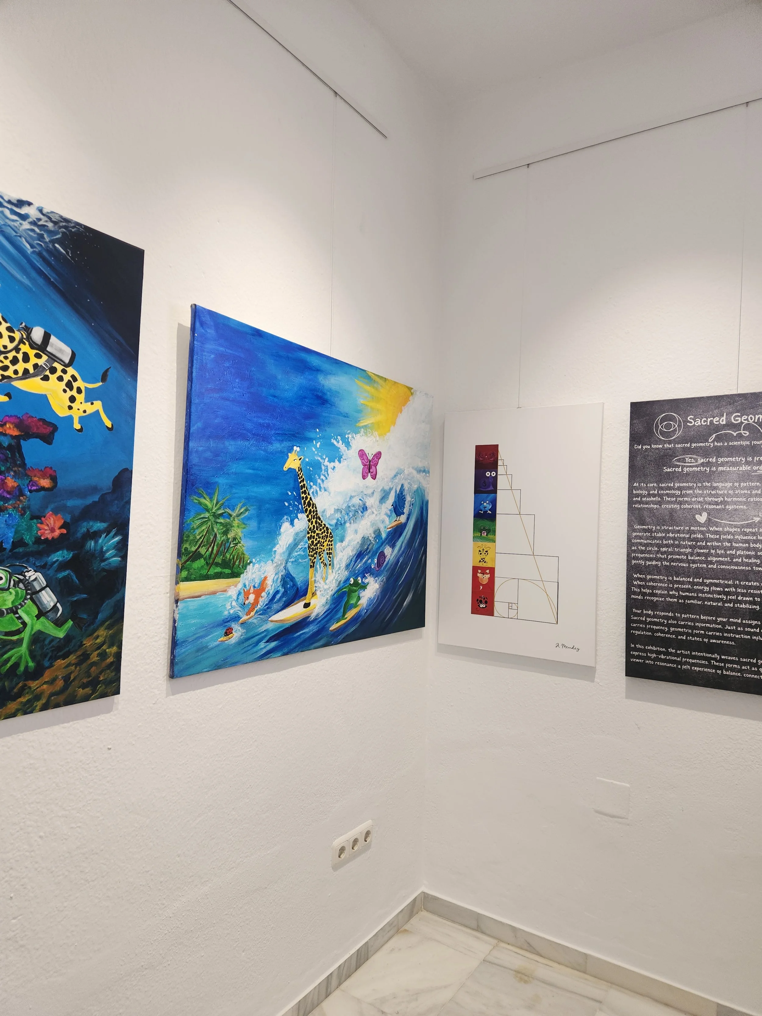 Colorful paintings and informational panels displayed on white gallery walls.