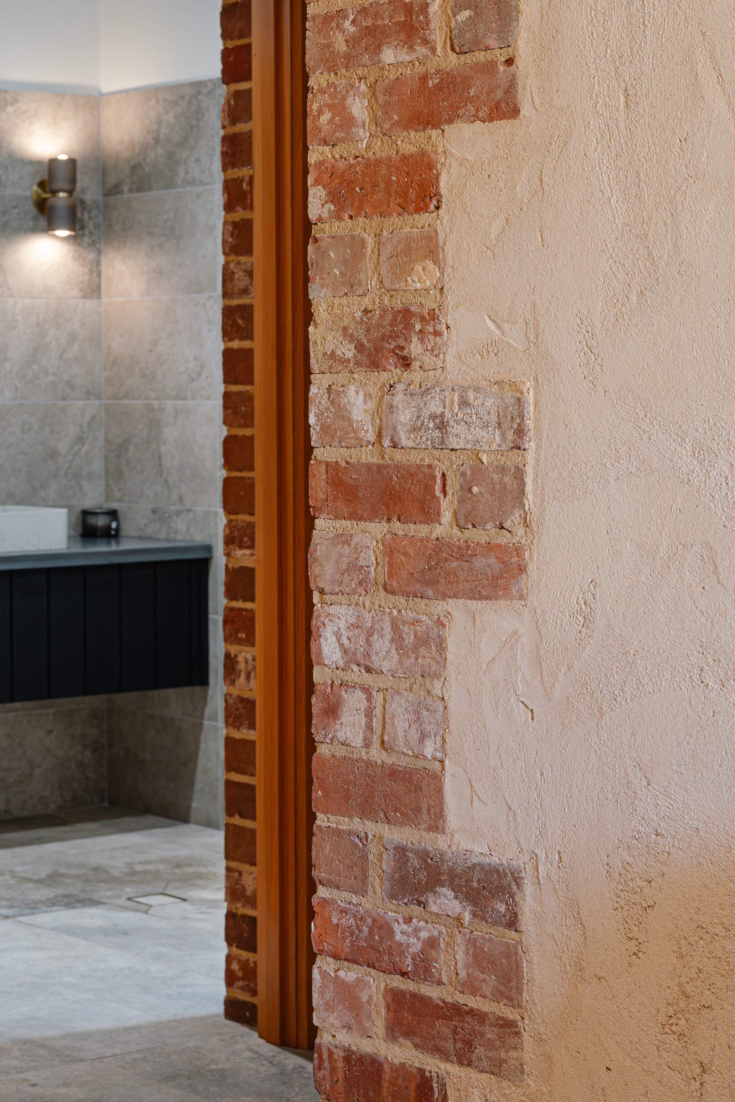 Original red brick pier on rendered sandstone walls, thoughtfully restored to retain original heritage character