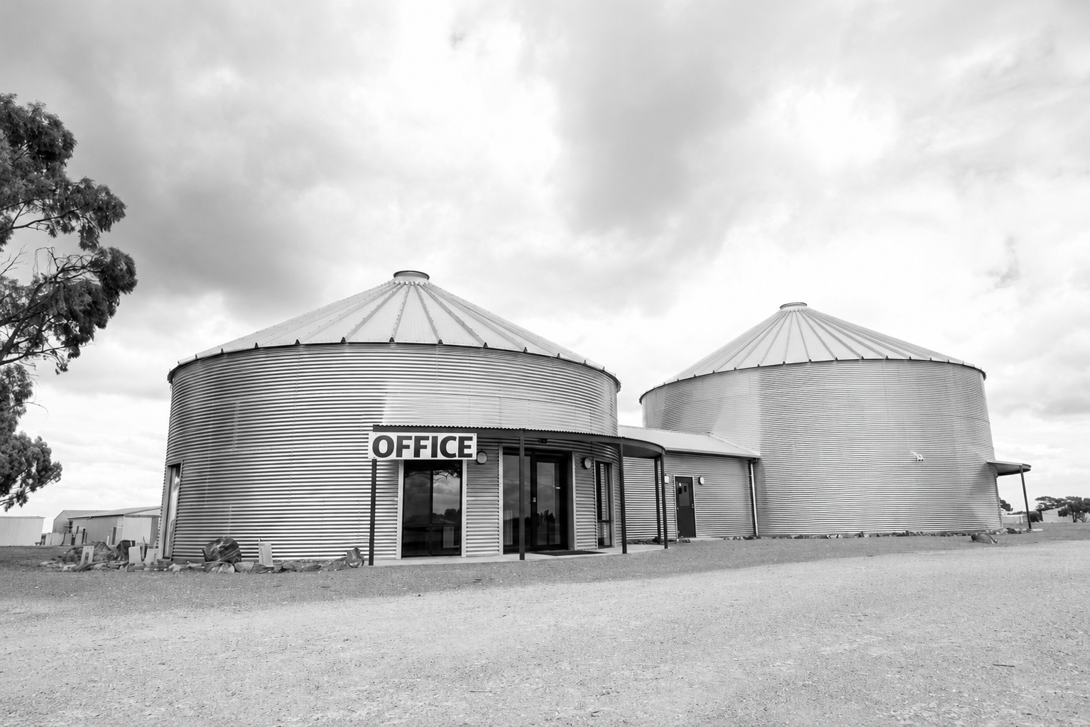 Corrugated silo-style office building at Paskeville Field Days, with OFFICE signage above the glass entry doors