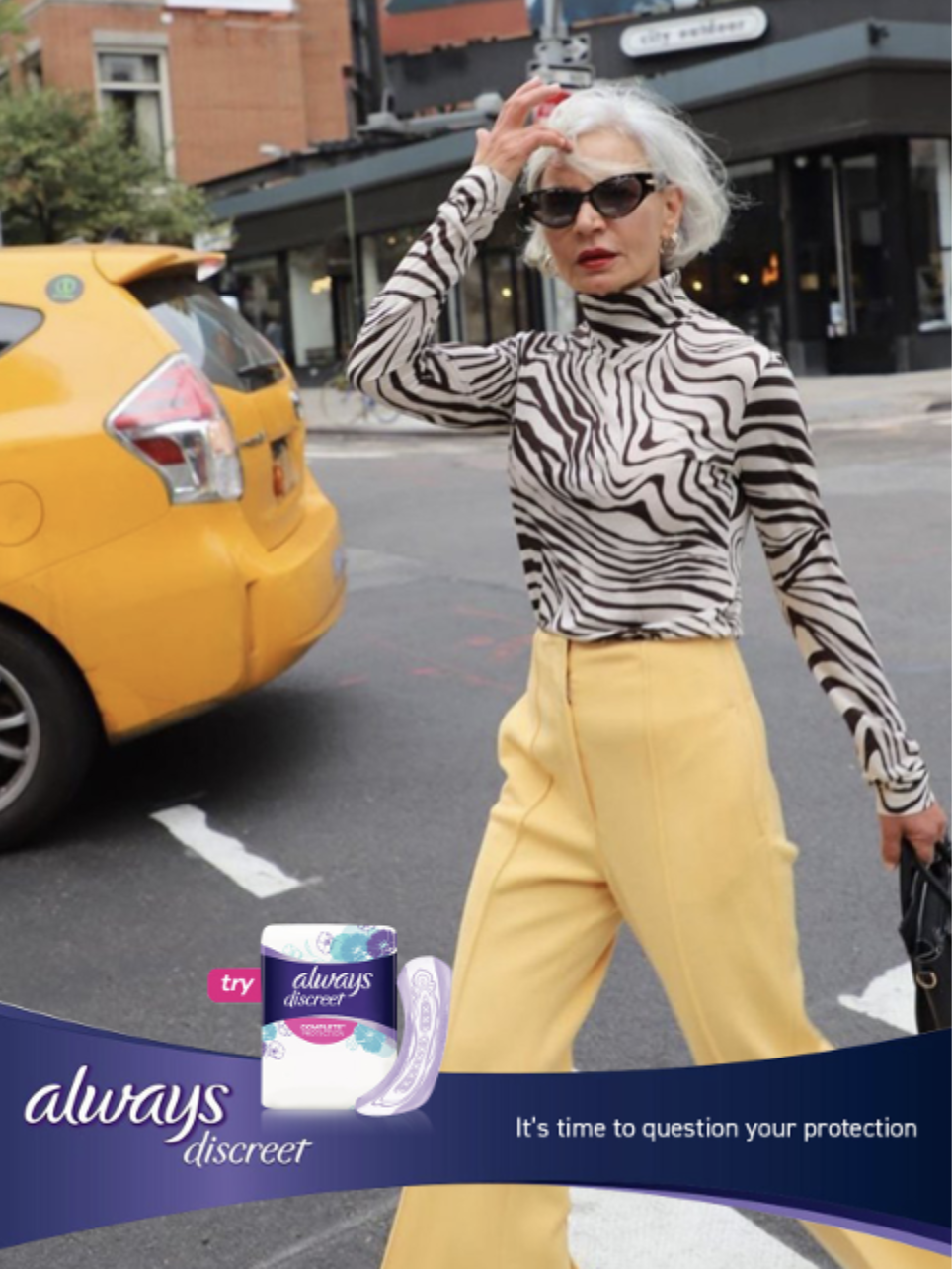 A woman striding through New York in yellow trousers