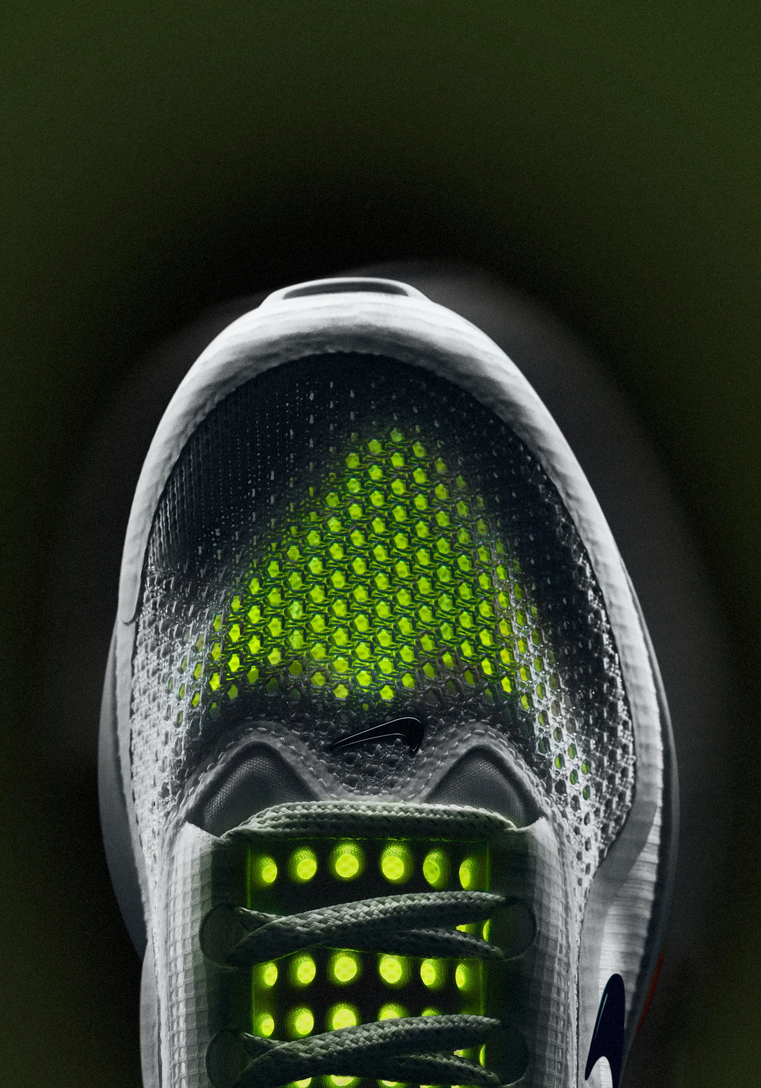 Top-down view of Nike ZoomX mesh upper with glowing green mesh, advertising retouching