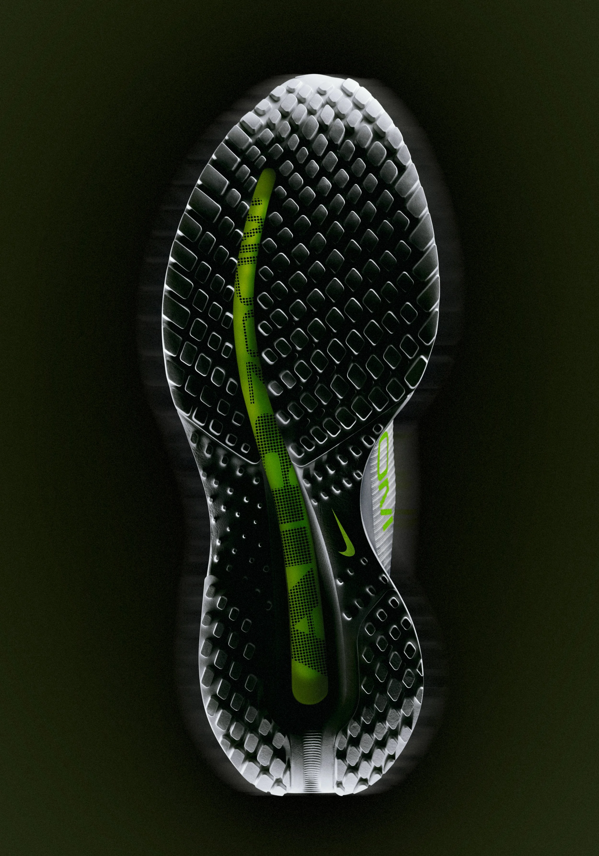 Full outsole of Nike ZoomX running shoe with green centre channel, retouched for campaign use
