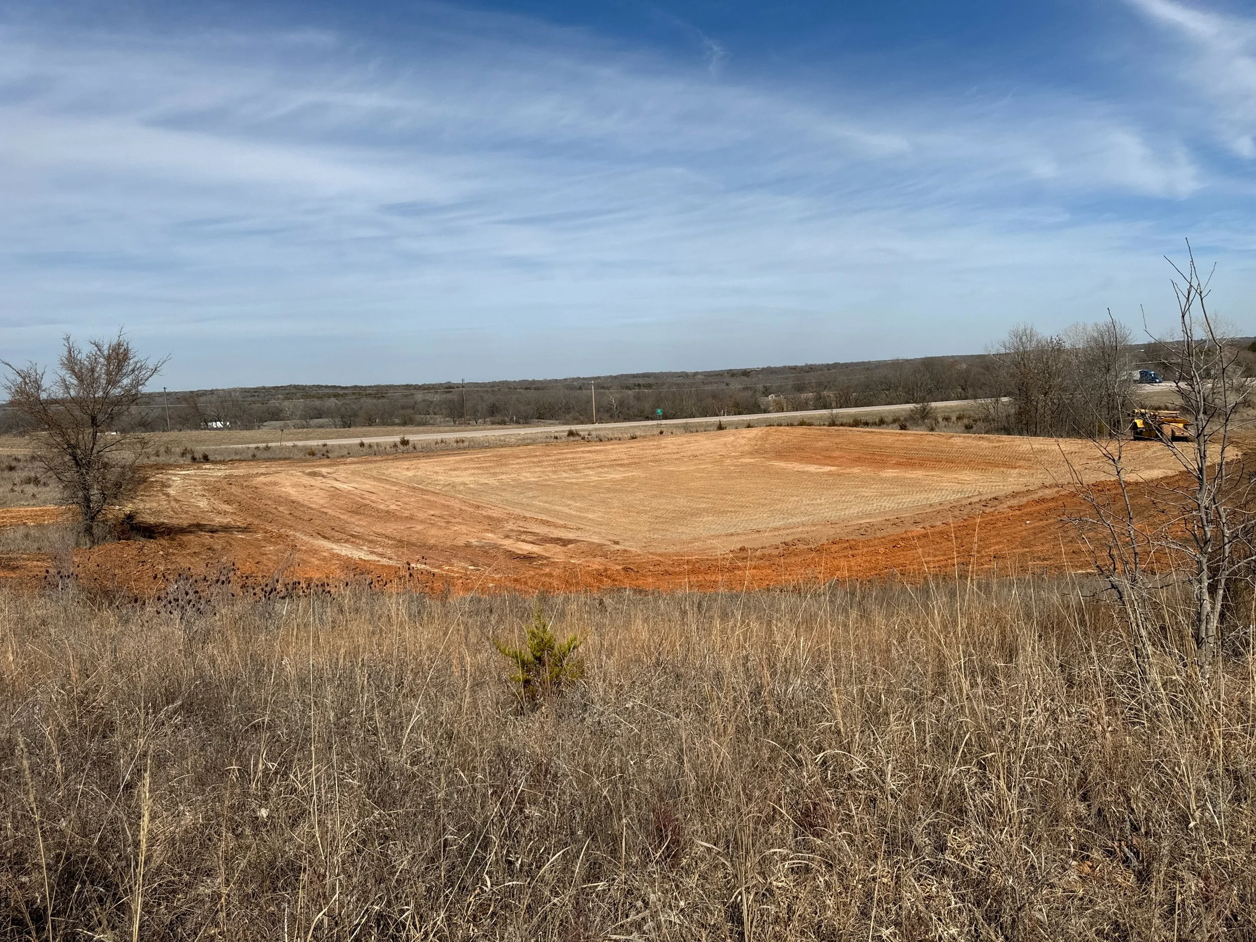 Cleared land with construction machinery in a rural area