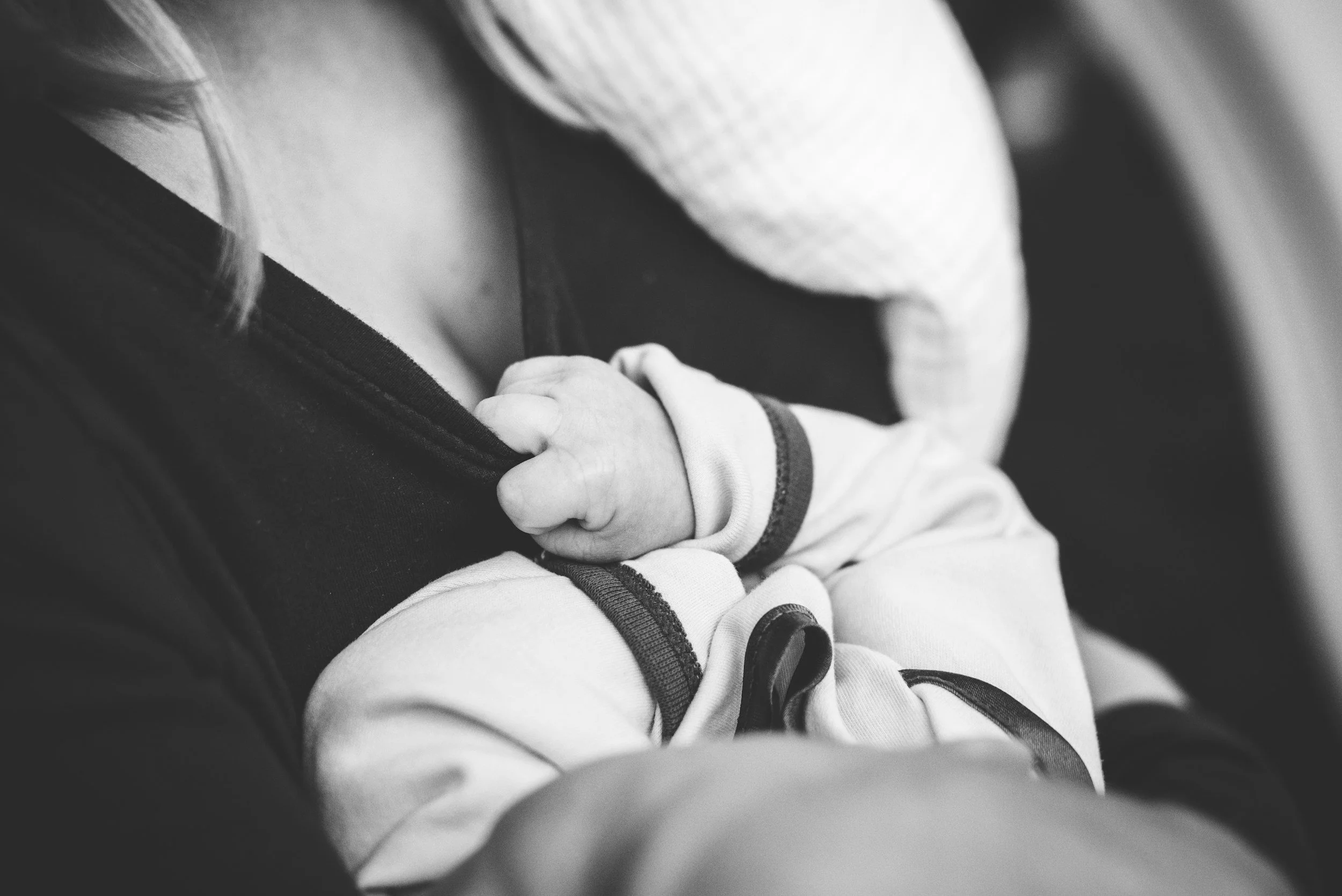 New mom holding baby online therapy for mothers in Medicine Hat