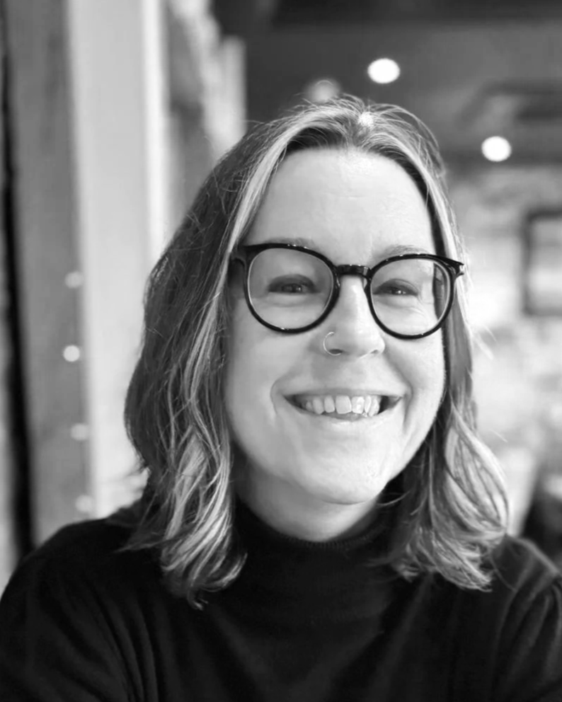 Tree, a teacher for queer and neurodivergent English learners , is looking right at the camera. She has glasses and a big smile!