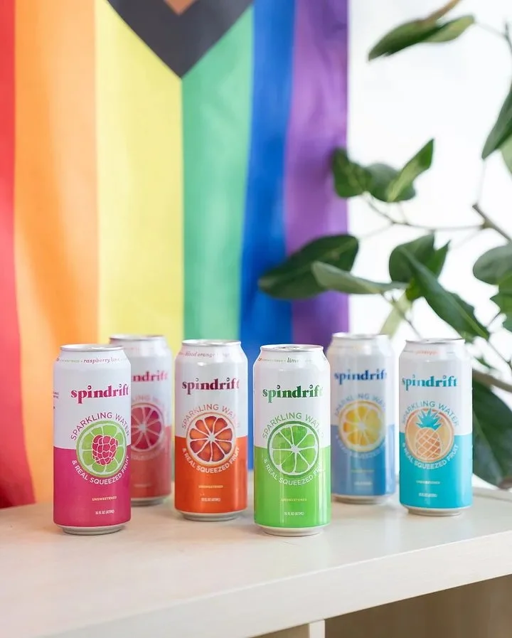  Two images side-by-side, each of six cans of spindrift. In the first, the colors of the cans are, in order, pink, peach, orange, green, blue, turquoise. In the second, the colors are, in order, pink, orange, peach, green, turquoise, purple. The purp