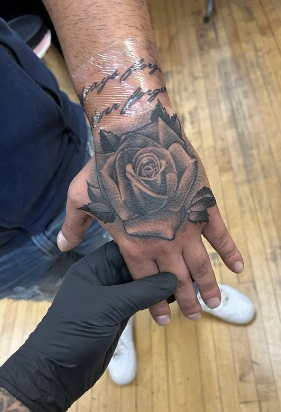 rose hand tattoo black and grey.jpeg