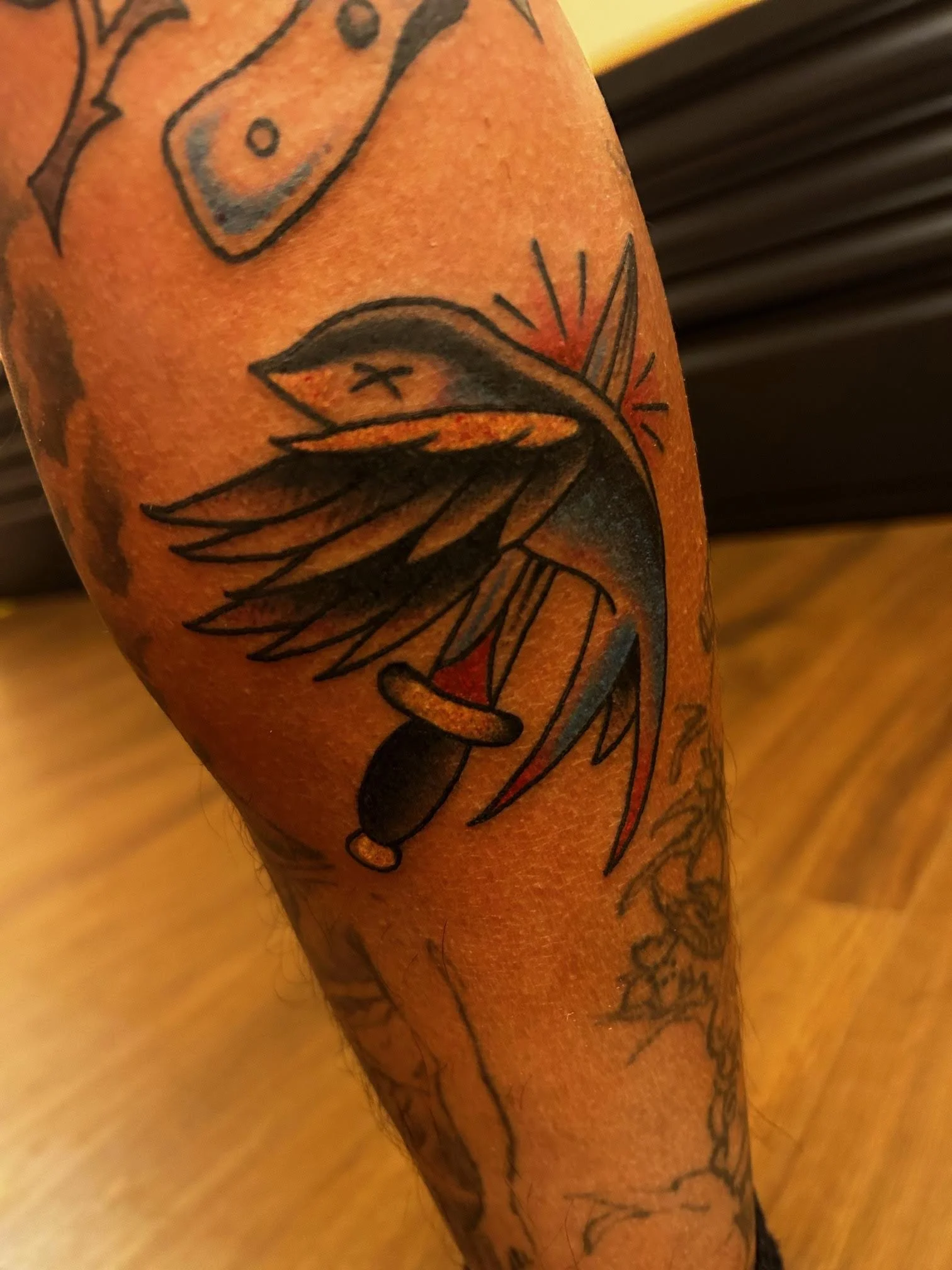 knife through swallow tattoo.jpeg