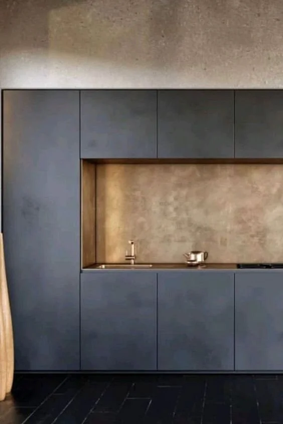 Cuisine moderne avec armoires grises, évier encastré et décoration minimaliste.