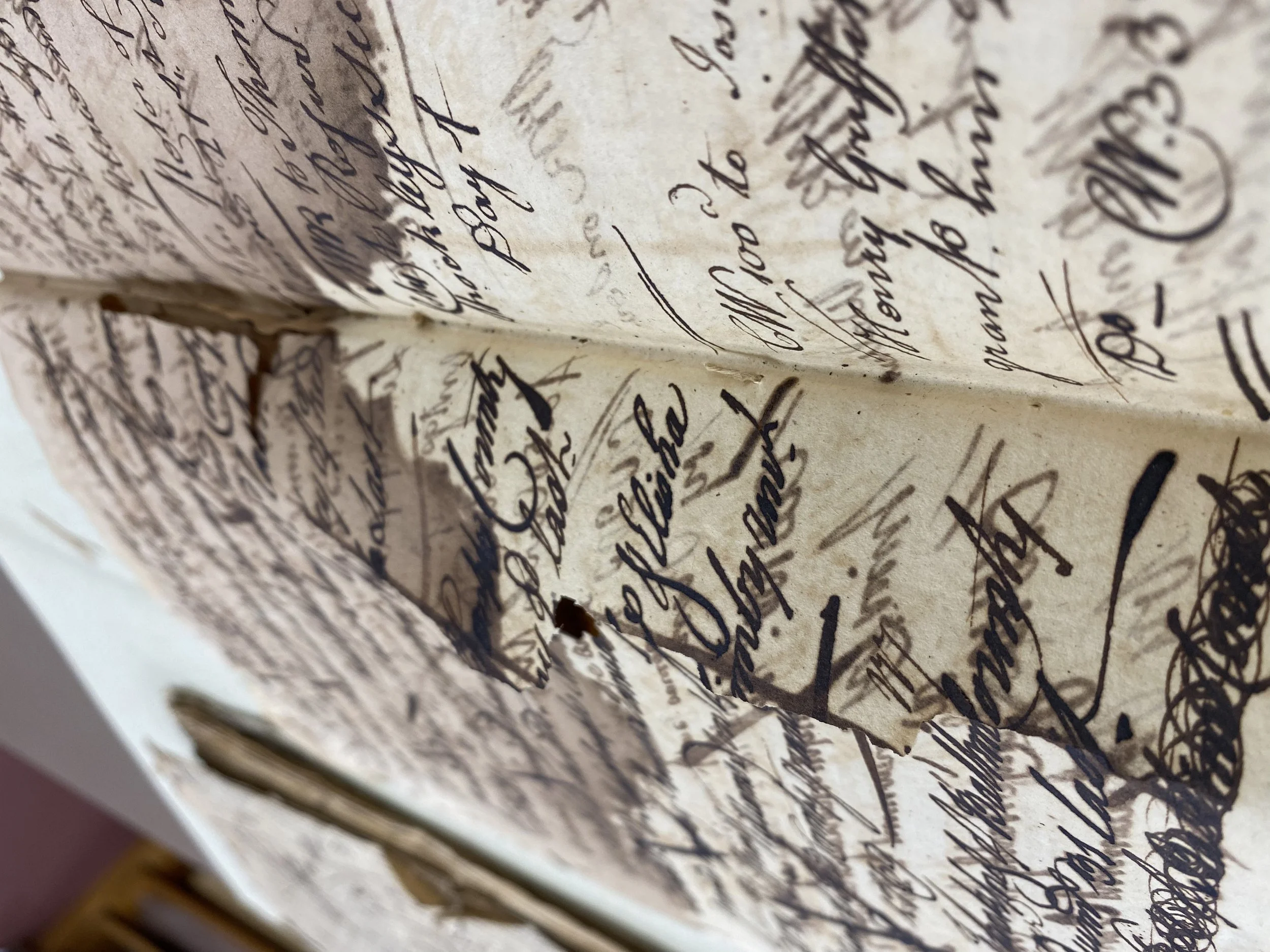 Rupturing of a page suffering damage from heavily-applied iron gall ink, used to
redact earlier text in iron gall ink.