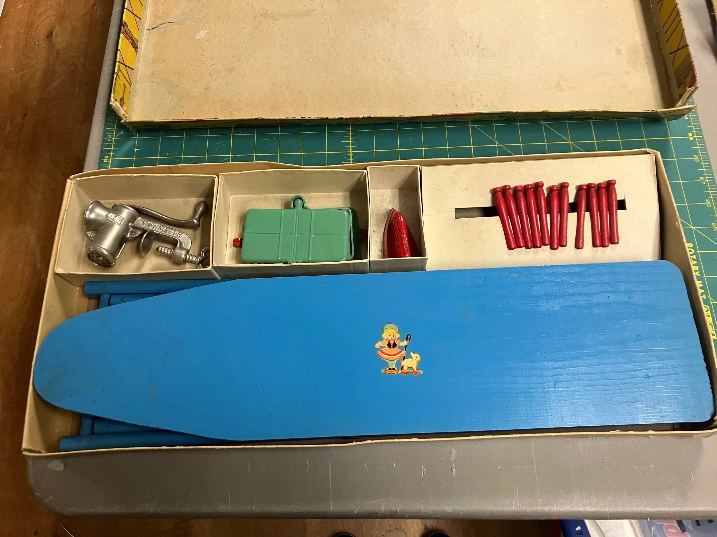 Box at the museum, before sending to us for conservation, showing the original antique toys which came in the box. (credit: Stephenson County Museum)