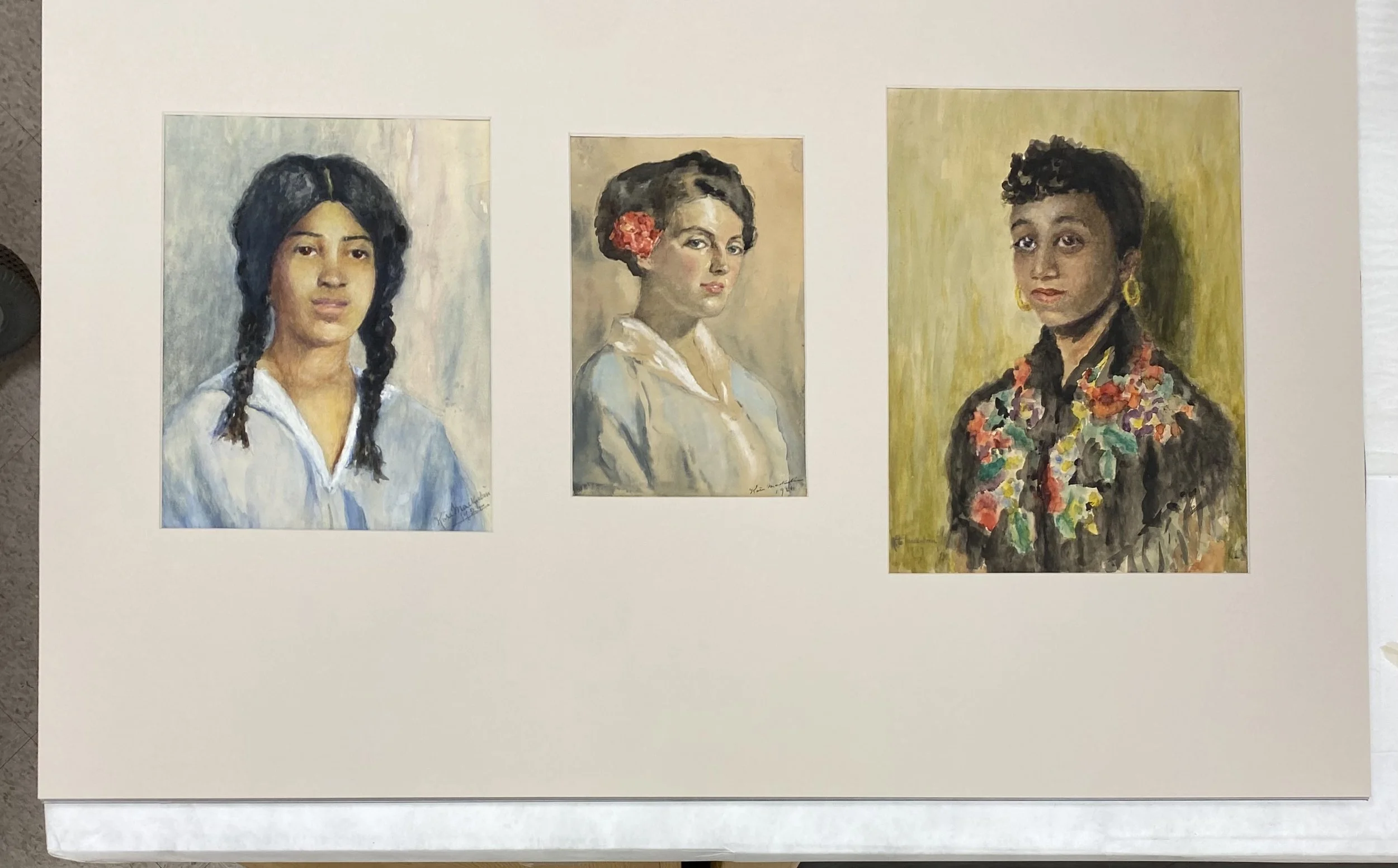 After treatment, a custom three-window mat of cotton rag board harmoniously unites the three portraits for exhibit.
