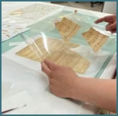 Comparing fragments in Mylar sleeves to puzzle pieces back where they belong.