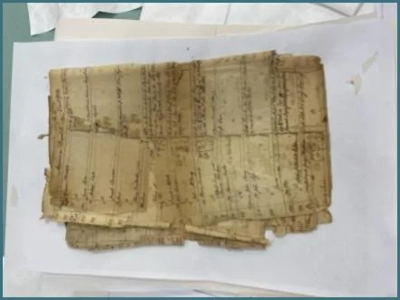 I adopted interleaving as a working strategy. Sometimes bond paper was further used
in sections of broken and folded-over sheets like these. Keeping track of where fragments were found was also helped by the interleaving.