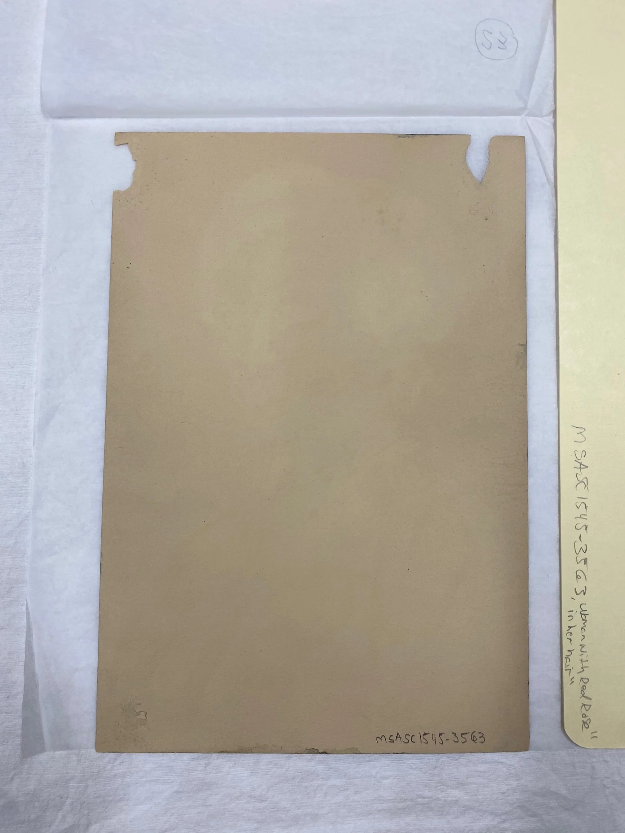 Before treatment, verso. Damage likely coincides with improper mounting method.