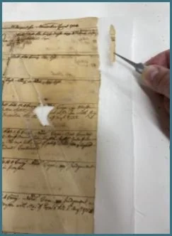 Densely written text with names and information at risk of becoming lost now being recovered. Even this small fragment carried more text than expected. Note also the great bleed-through of Iron Gall ink where this paper received water damage.