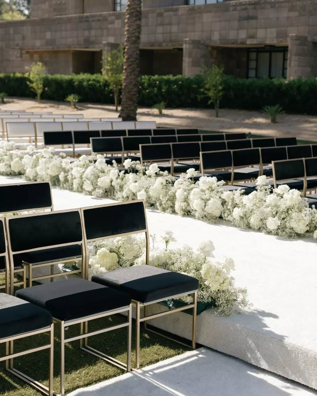A ceremony this scale needed a chair that could hold its own.

Pearl Dining Chairs in black and white - same chair, two tones, one aisle. The gold frame ties it together without trying too hard. Big venue, clean concept, nothing fussy about it.

This