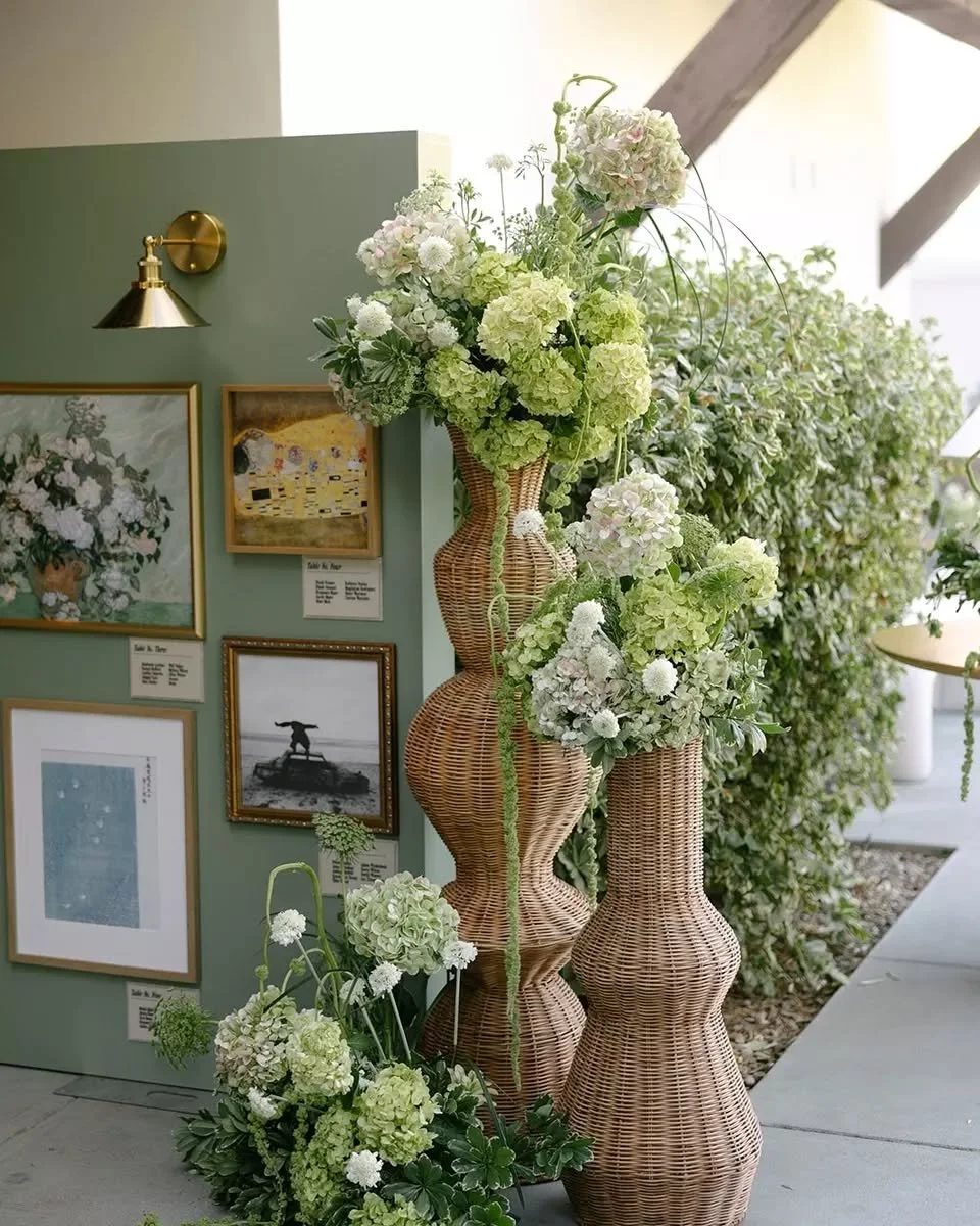 A forever favorite design moment for us - turning a display wall into a custom art installation at @elchorroweddings. We gave our 6'x7' wall a custom paint job in Prim Green + installed framed art, seating assignments, and gorgeous gold sconces. 
.
.