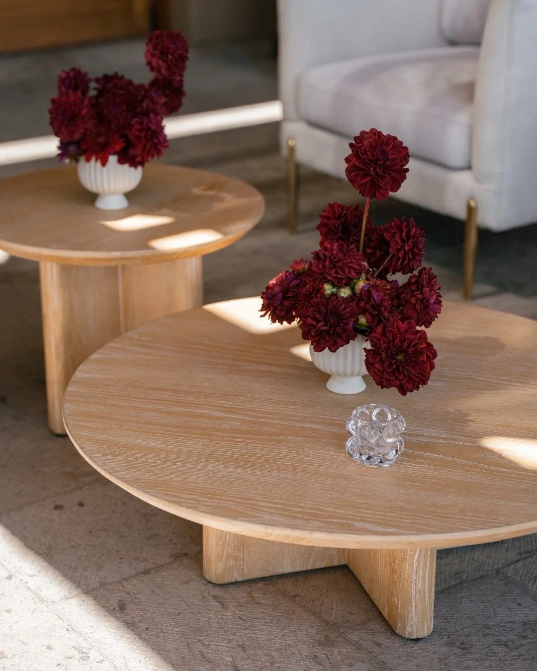 Deep red dahlias on natural oak and the afternoon sun cutting across the Kinsley Coffee Tables just right 🌿

The Michelle Sofa and Chairs kept it grounded and warm - the kind of lounge setup that makes cocktail hour feel like somewhere guests actual