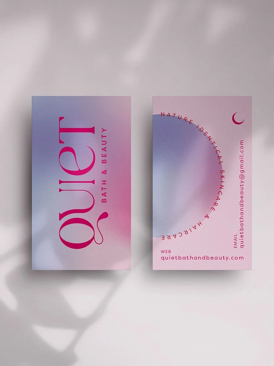 Pink and purple gradient business cards for Quiet Bath and Beauty placed on a white surface, with shadows cast nearby.
