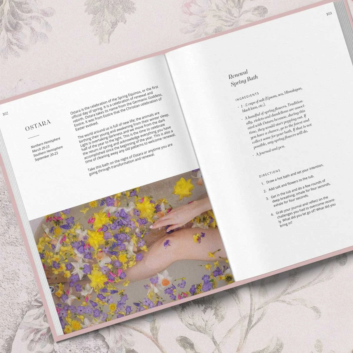 Inner page of The Witch’s Bath Book by Cosmic Valeria, showing the “OSTARA” section with minimalist text layout and a photo of a hand among spring flowers.
