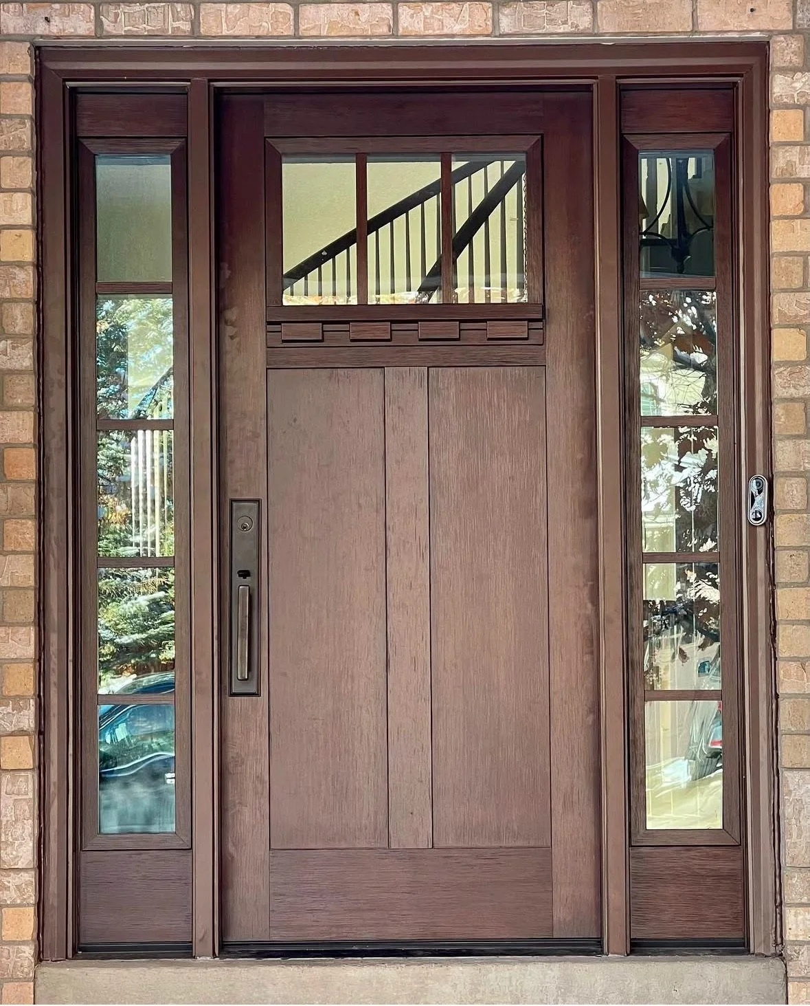 New ProVia fiberglass entry door with craftsman glass and matching sidelites, installed on a Denver-area brick home by Apex Energy Solutions