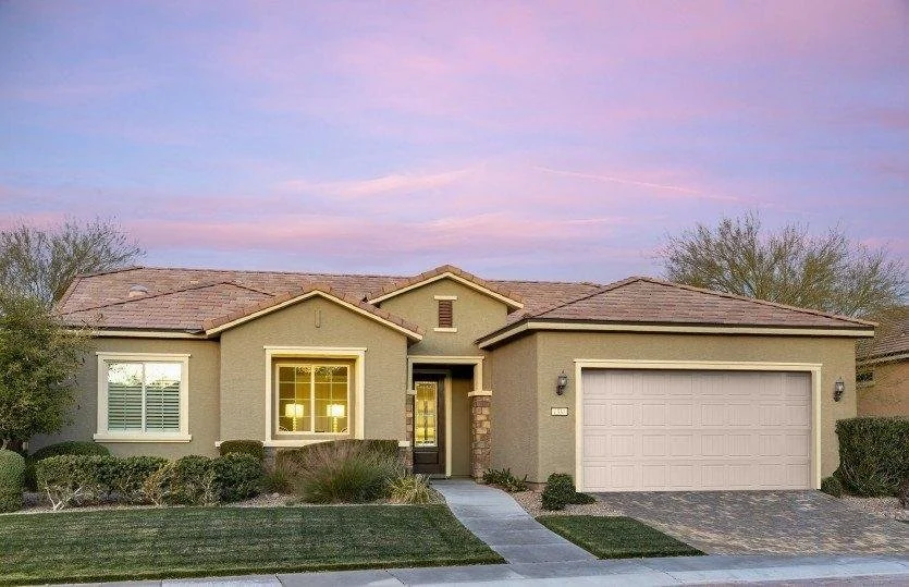 Single-story Nevada home with stucco exterior, tile roof, attached garage, and accessible front entry.