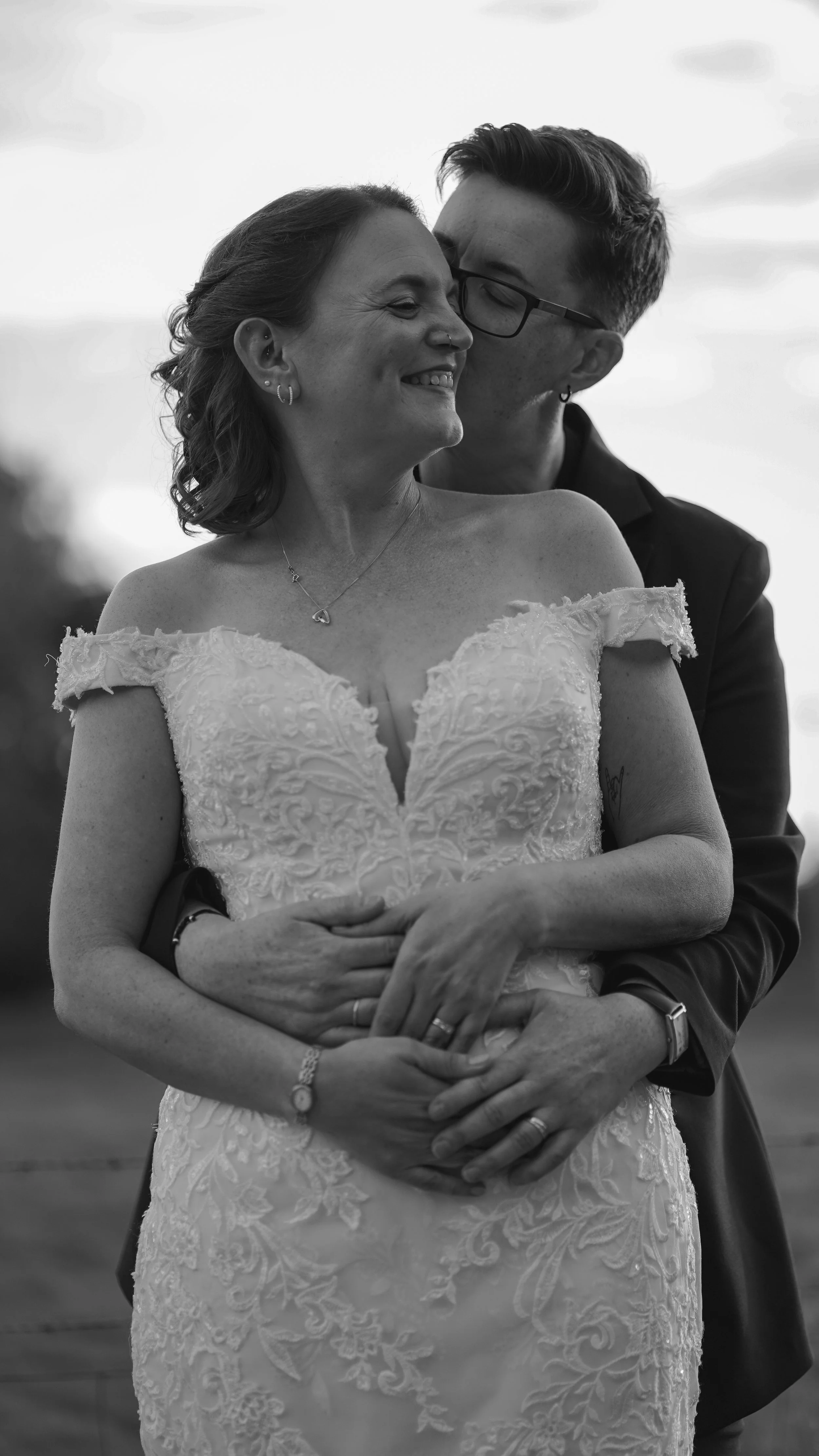 A black and white photo of a two wonderful women sharing a loving moment on their wedding day.