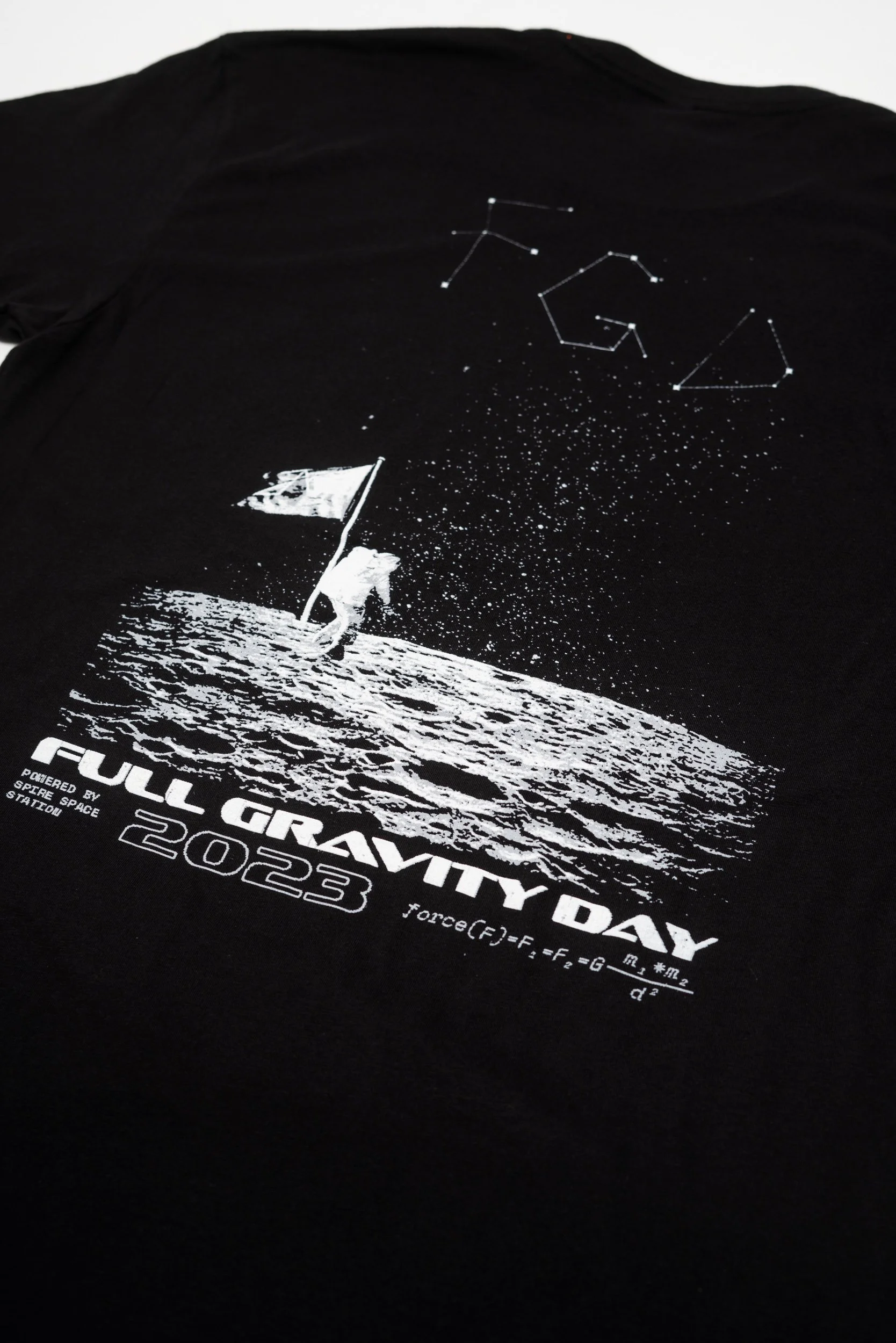 Black T-shirt with white space-themed graphic and text celebrating the 50th anniversary of the moon landing on July 20, 2023