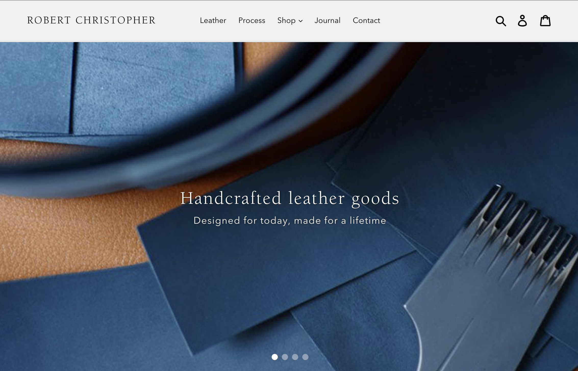 Blue leather pieces and crafting tools on a website banner for handcrafted leather goods.