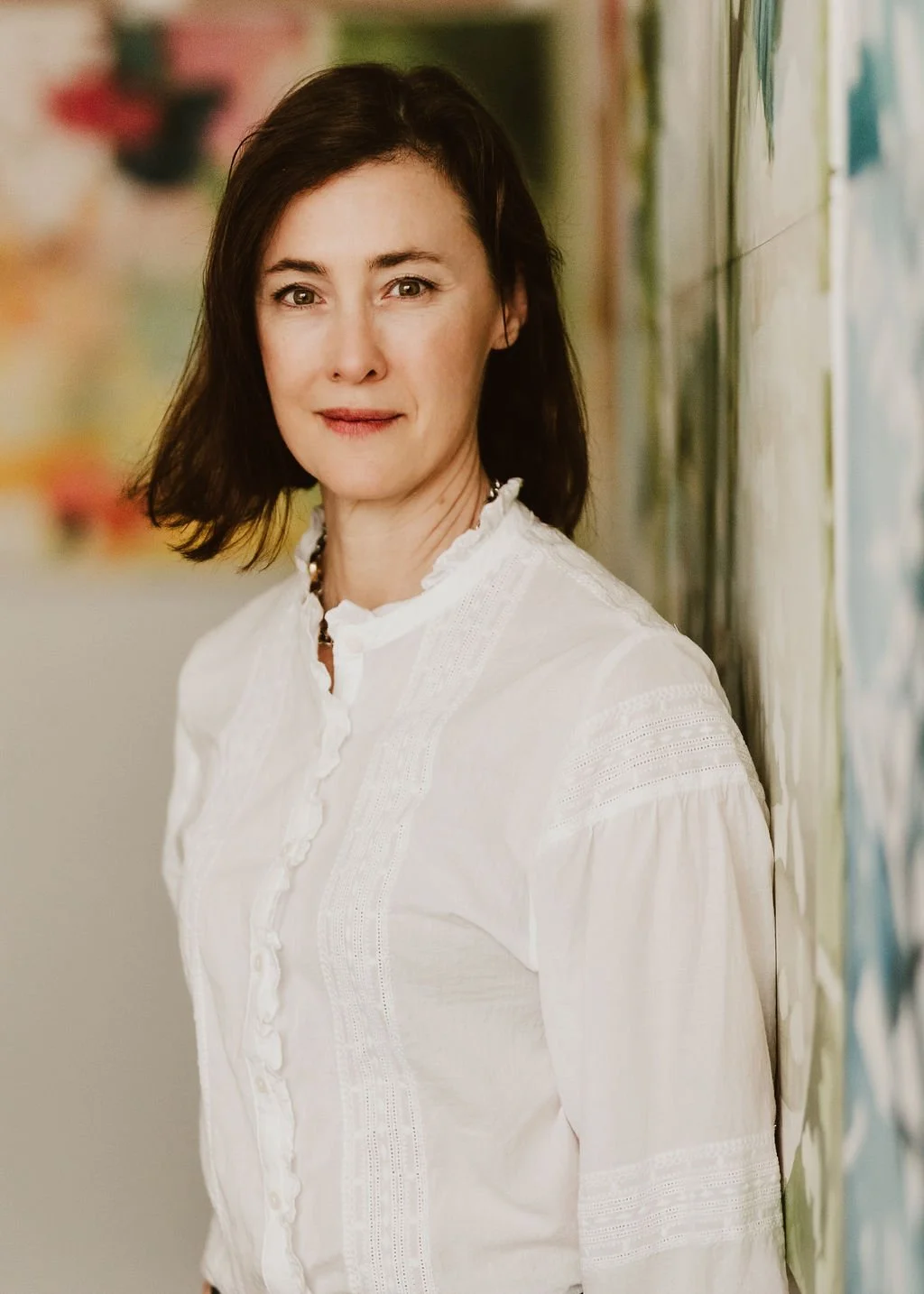 Woman in white blouse with artistic background