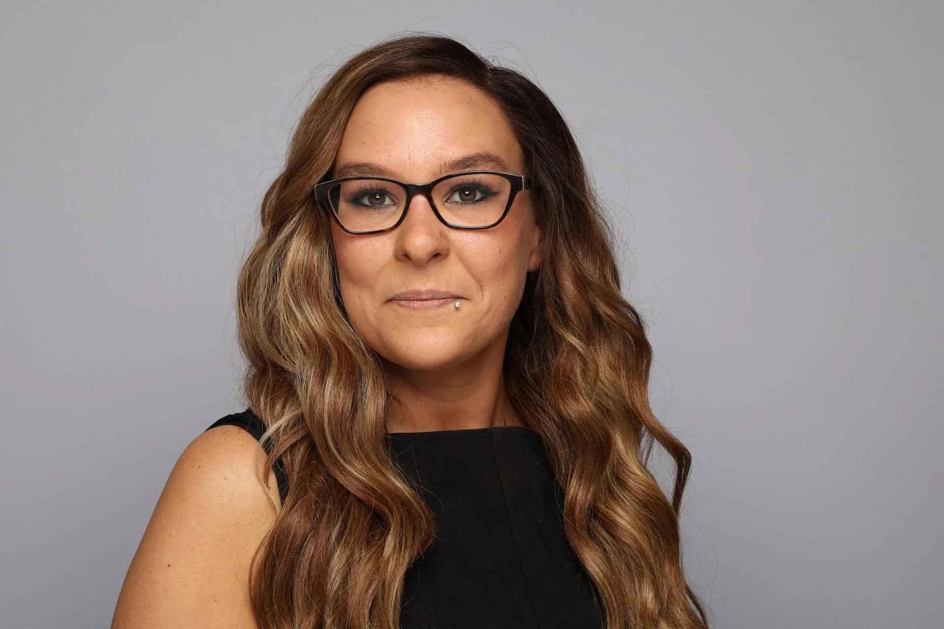 Memphis Headshot of Woman in Sleeveless Black Top and Glasses