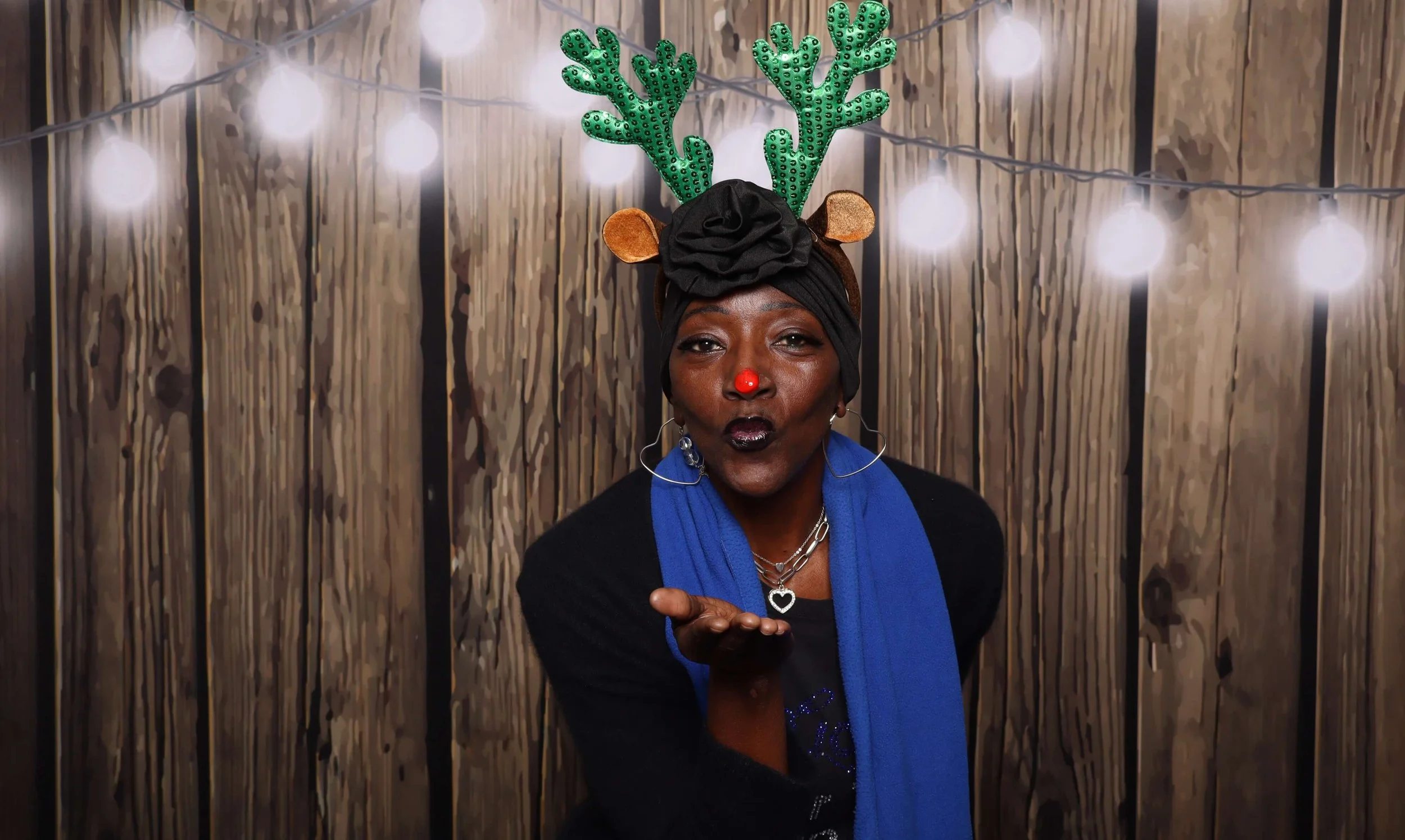 Holiday photo booth in Memphis women in antlers blowing kiss