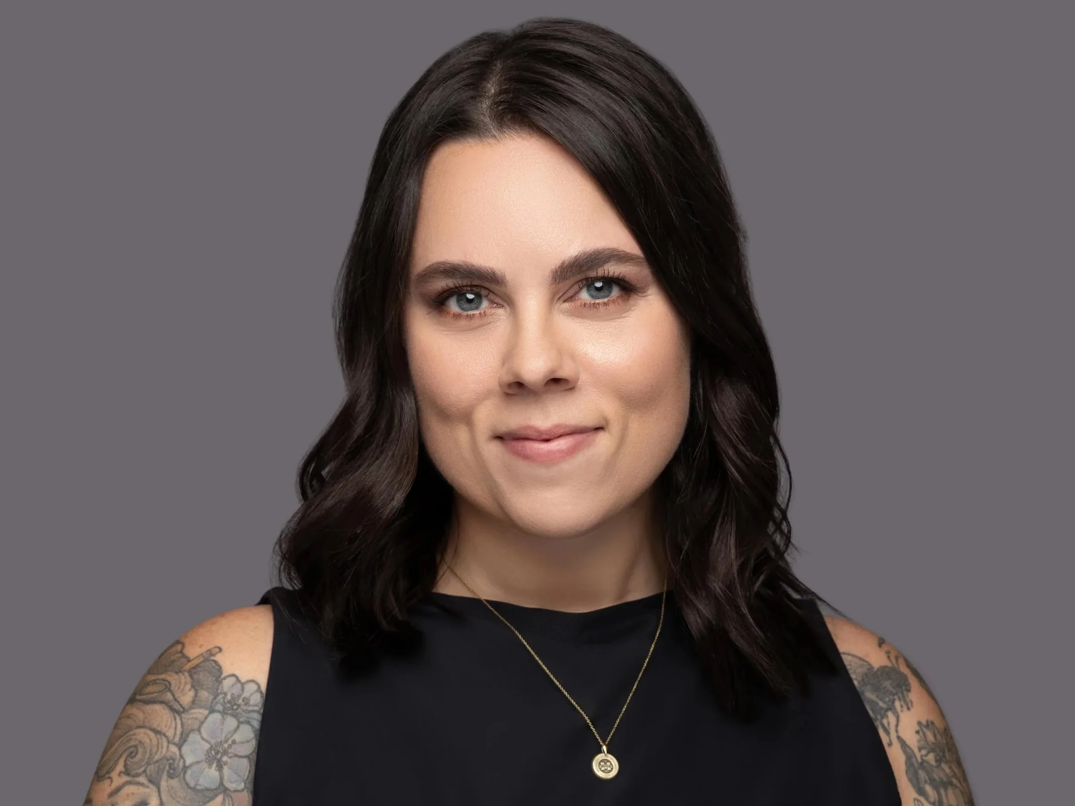 Memphis headshot of woman in black tank on gray