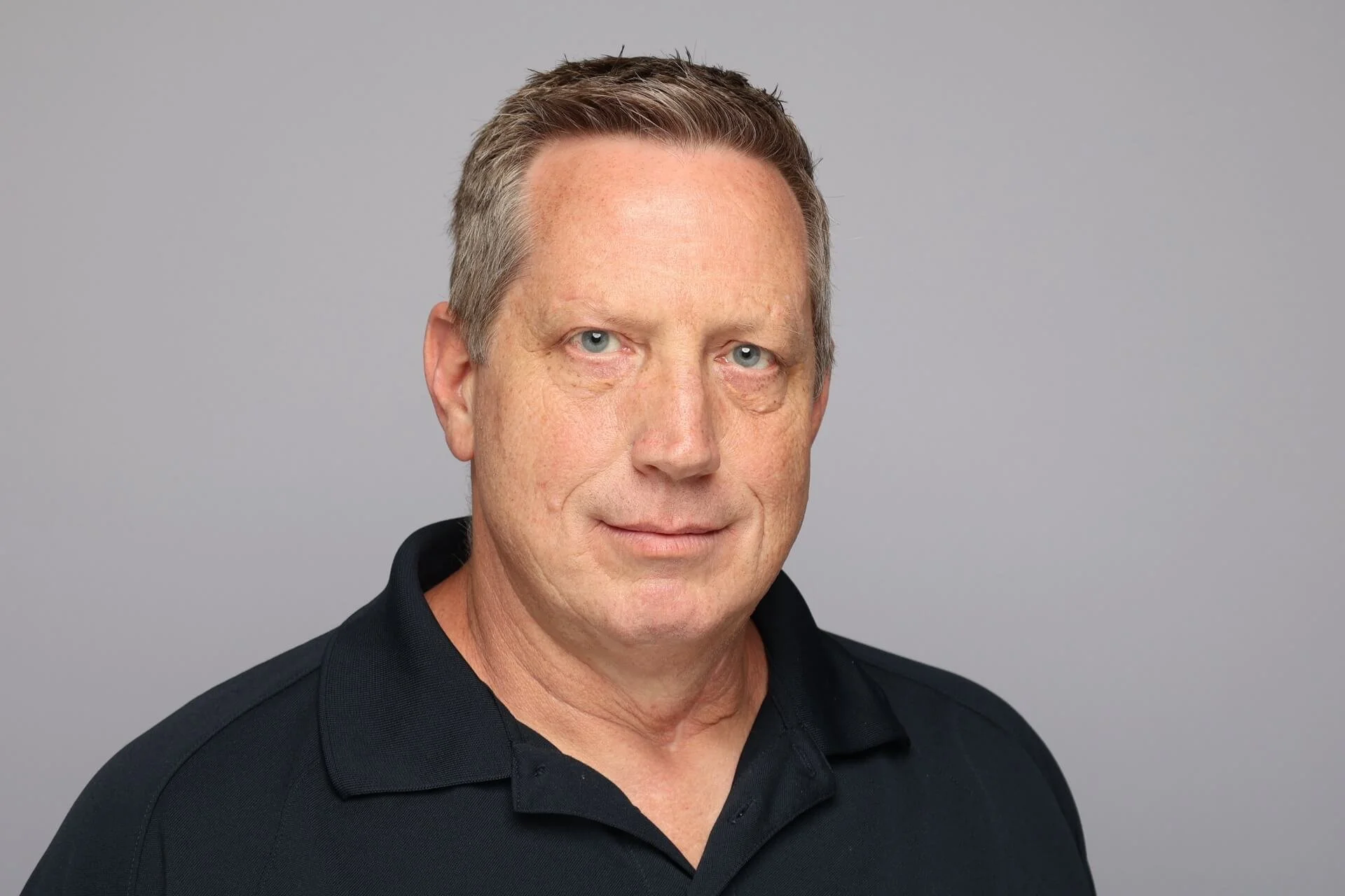 Memphis Headshot of Man in Black Polo