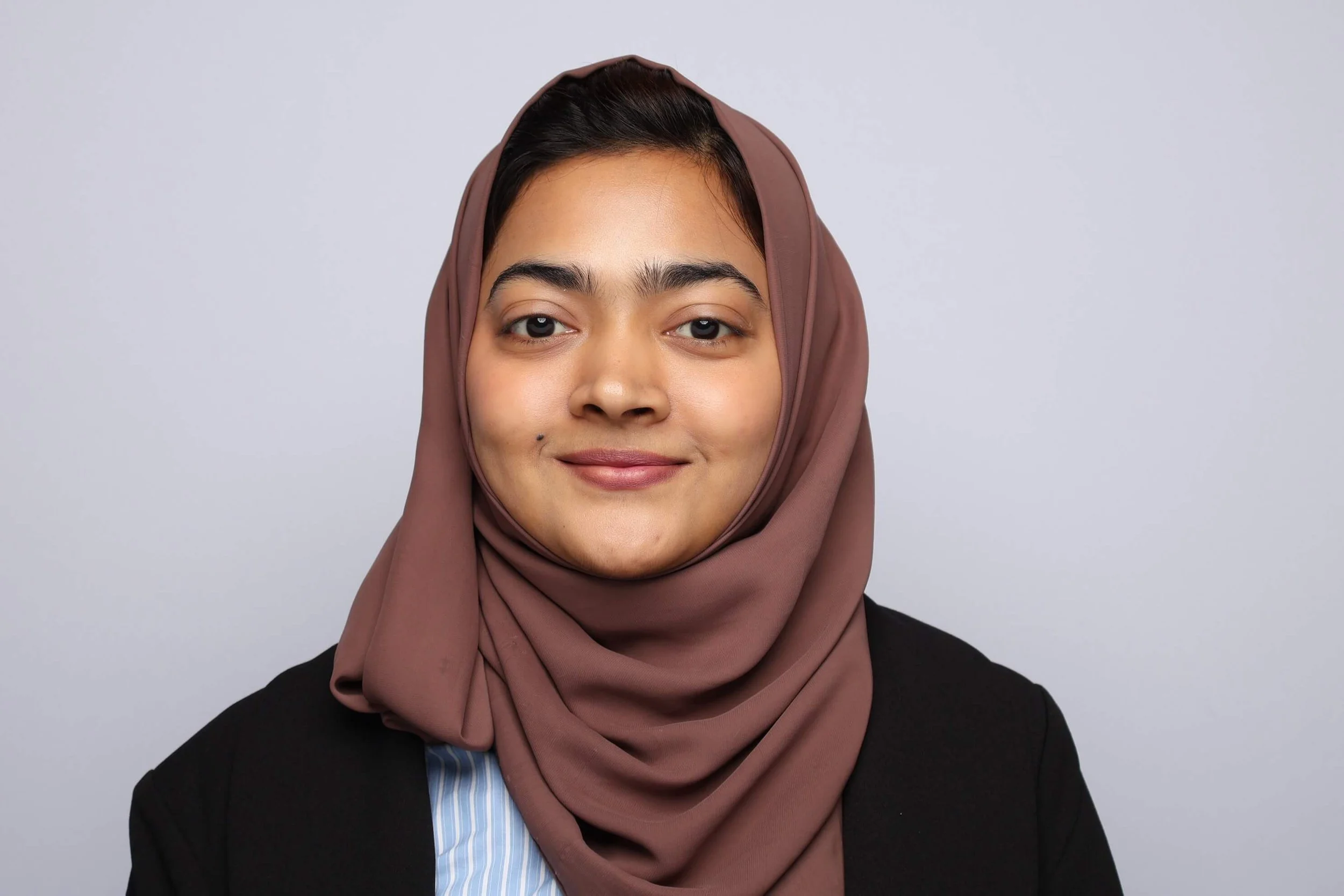 Memphis Headshot of Woman in Black Blazer and Head Covering
