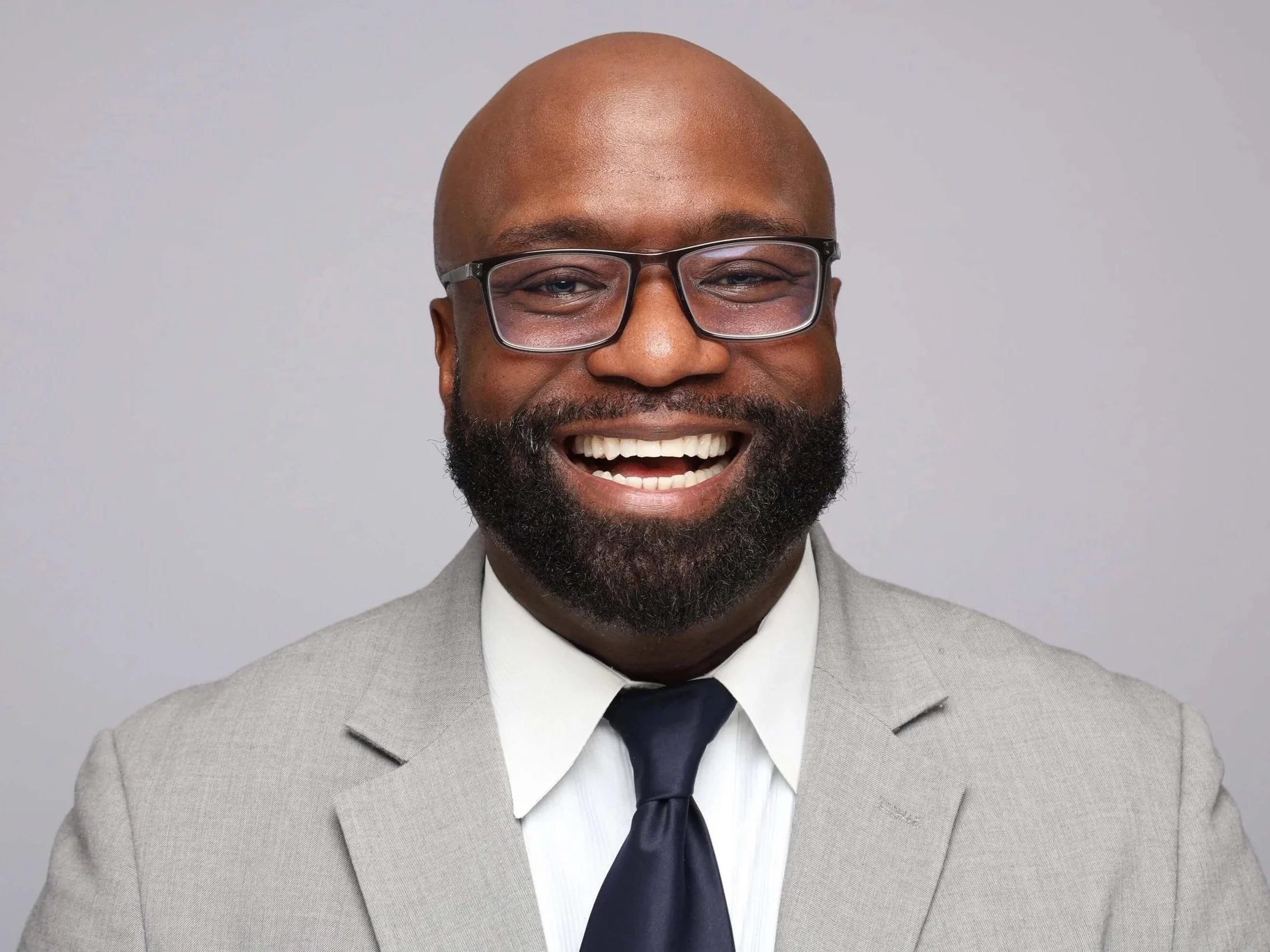 Memphis Headshot of Man Smiling in Tan Suit Jacket