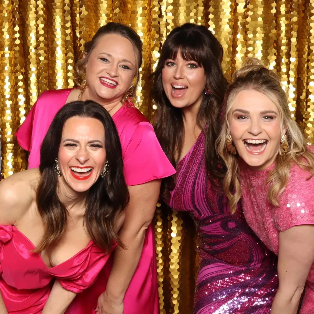 Kelly+Gin%2C+Emma+Cockerham+and+friends+at+the+Glitz+Gala+in+front+of+a+gold+sequin+backdrop+in+the+Classic+Photo+Booth.webp
