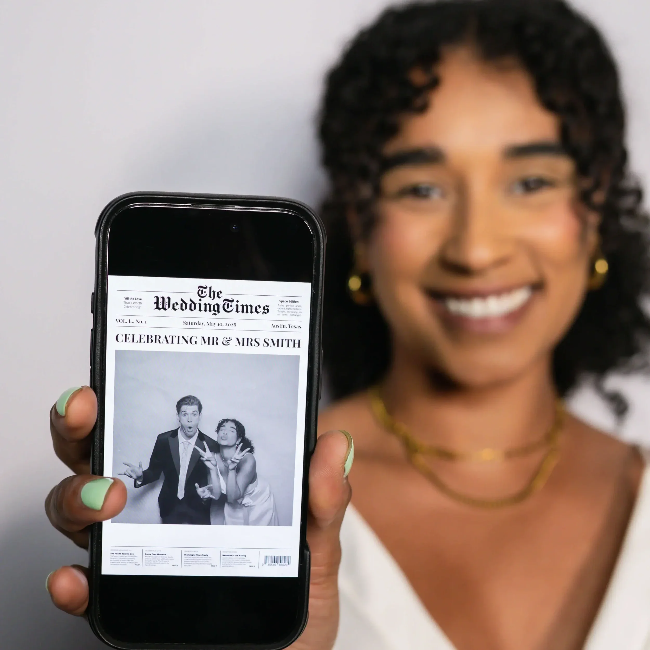 olive branch bride showing off newspaper photo booth