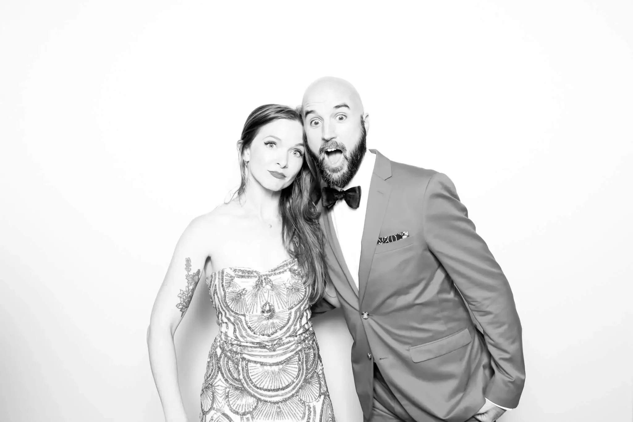 bride and groom pose for glam photo booth in olive branch