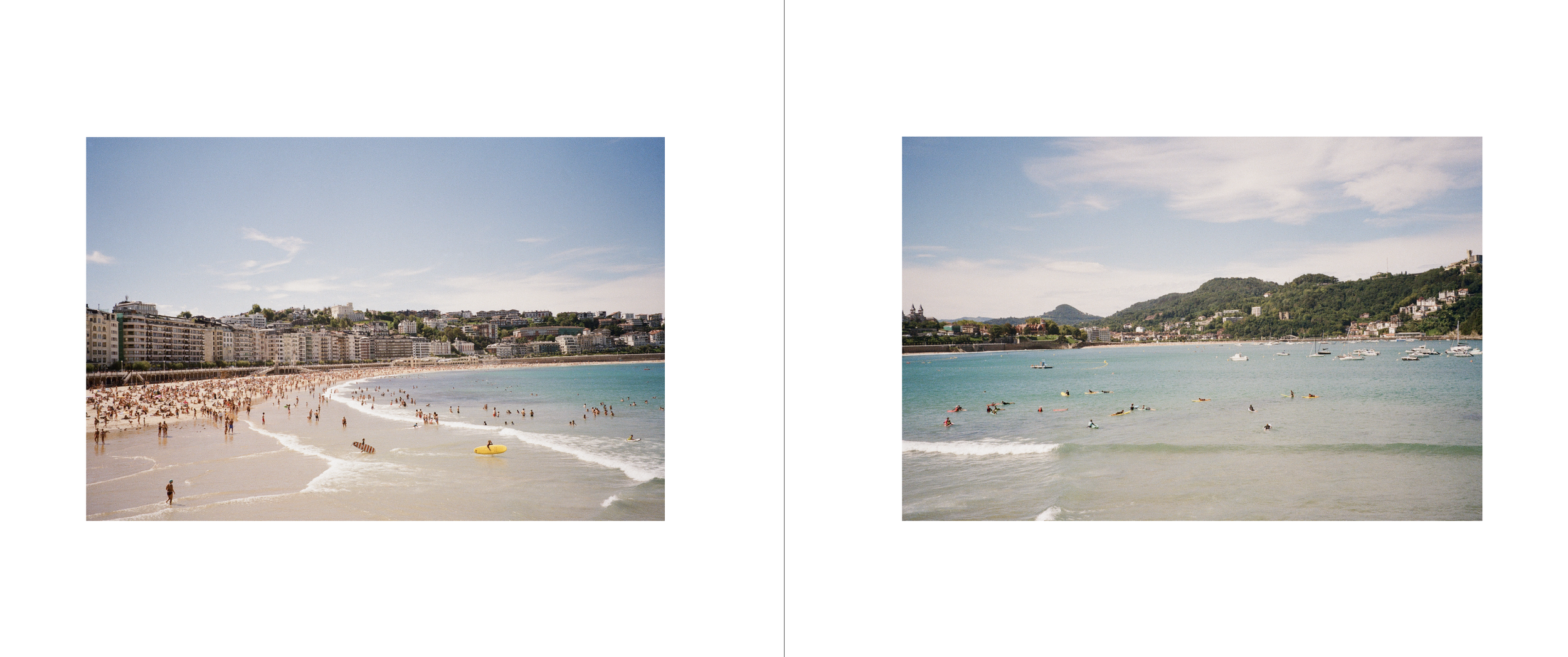 Beach with crowded shoreline on the left and a calmer, less crowded area on the right, both with people swimming and relaxing in the water under a partly cloudy sky.