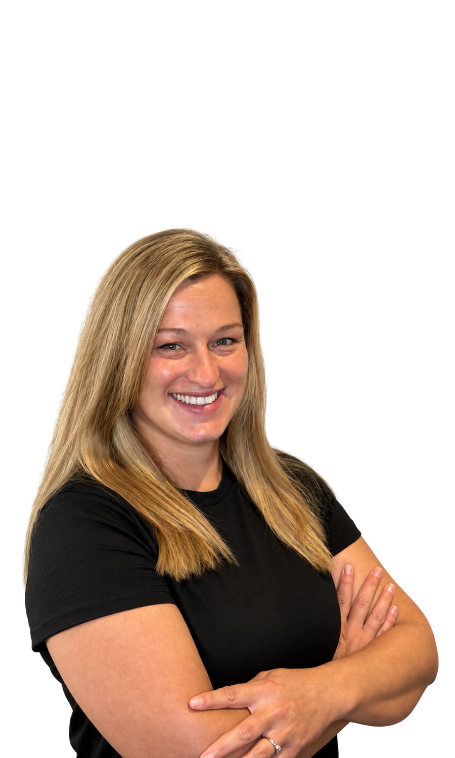 A smiling woman with blonde hair, wearing a black shirt, has her arms crossed.